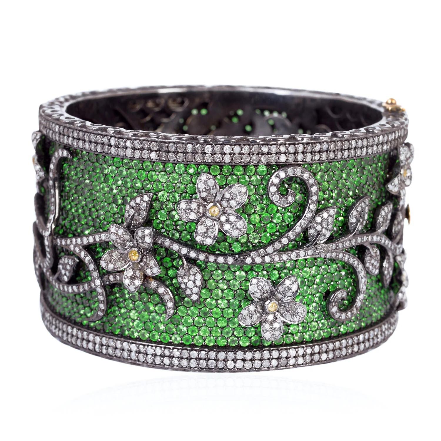 Inspired by the Mughal Era, a stunning statement bracelet handmade in 14K gold and sterling silver. It is set in 51.84 carats tsavorite and 15.66 carats of diamonds in blackened finish. A true masterpiece.  Clasp Closure.  Part of our Vintage