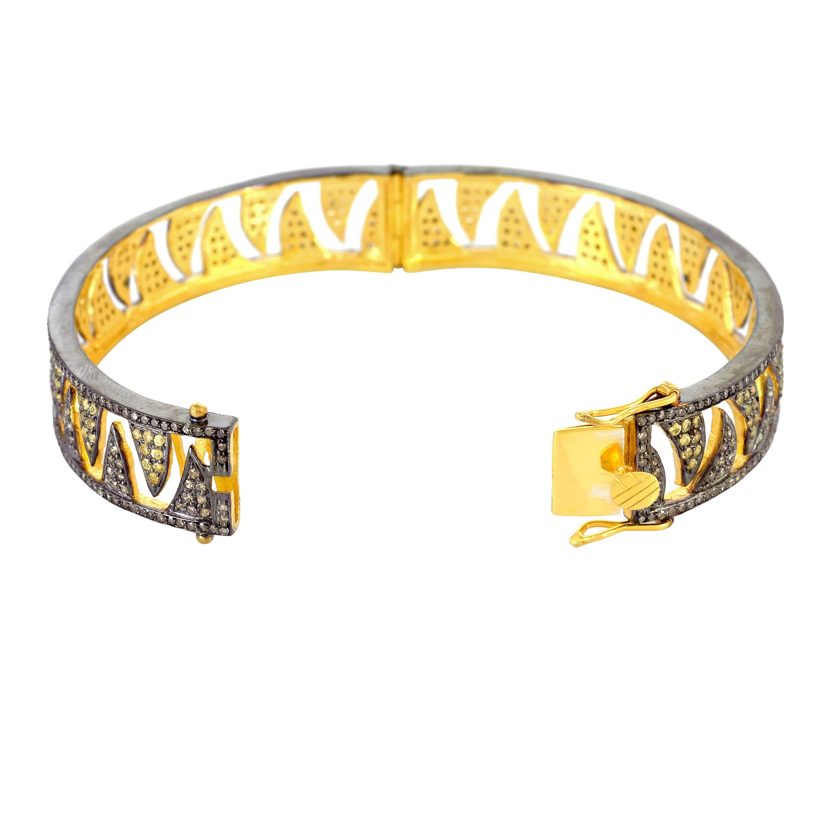 This Meghna Jewels Claw bracelet with interlocking claw pave arches looks ultra modern & stunning with sparkling yellow sapphire and champagne diamonds. Cast in 18K Gold and sterling silver. It is hand set in 2.27 carat champagne diamonds and 1.70