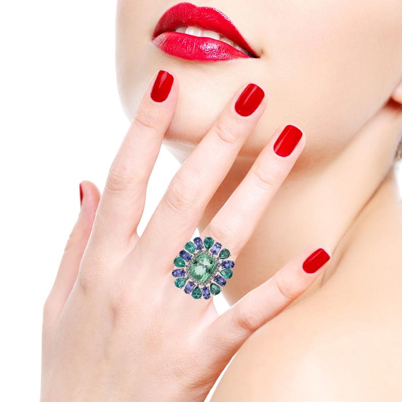 This ring has been meticulously crafted from 18-karat gold and hand set with Tourmaline, Emerald, Tanzanite and .22 carats of sparkling diamonds.

The ring is a size 7 and may be resized to larger or smaller upon request. 
FOLLOW MEGHNA JEWELS