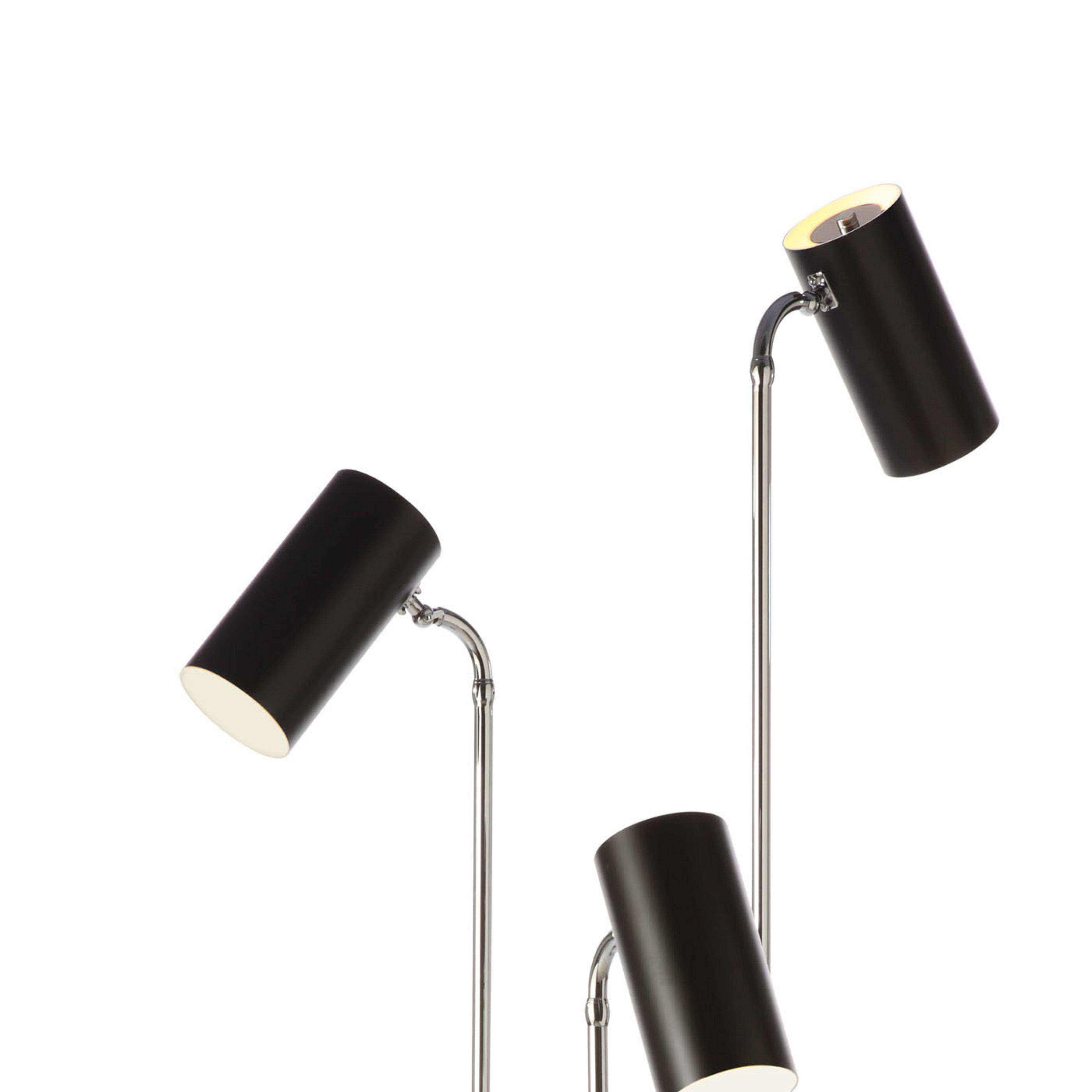 This striking floor lamp is entirely made in metal and features a cylindrical base finished with a black varnish resting on a round chromed support. From the base, three chrome-finished metal shafts sprout like modern stems of flowers and curve at