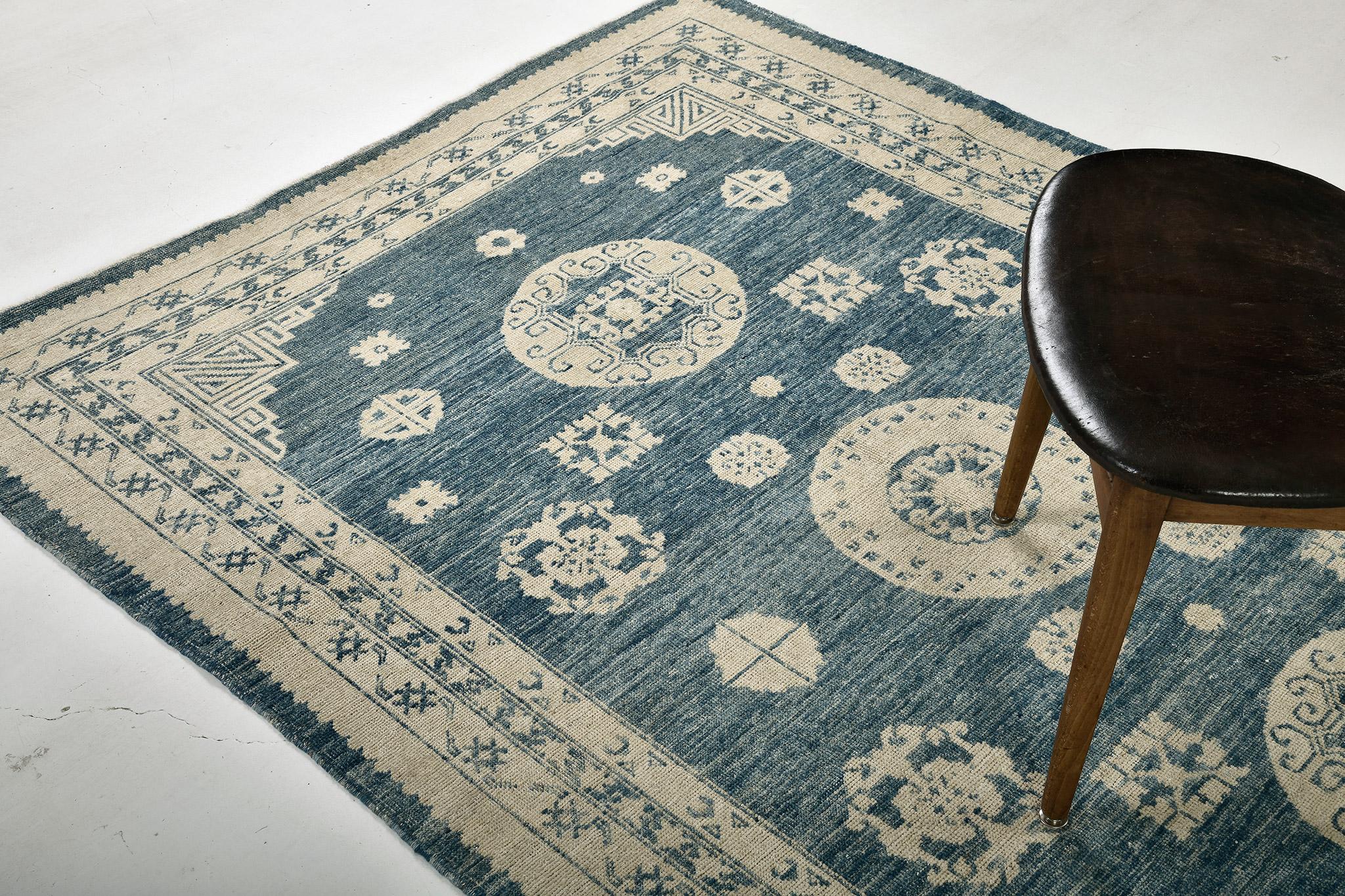 A vibrant and elegant Khotan design revival rug that will surely captivate every stylish mind. Featuring the three ornate medallions surrounded by majestic oriental elements in an abrashed vivid azure field, this rug was meticulously made from hand