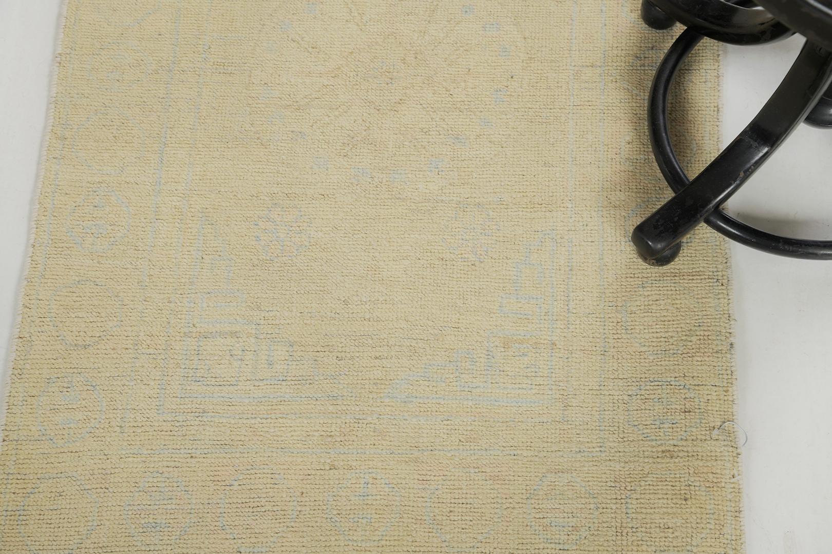 Stylized motifs and elements in camel tones of field and blue outlines express the entire pattern of the rug. This incredible rug is flexible for any home core decor. An amazing hand-spun wool Khotan design revival from our Muted Collection has come
