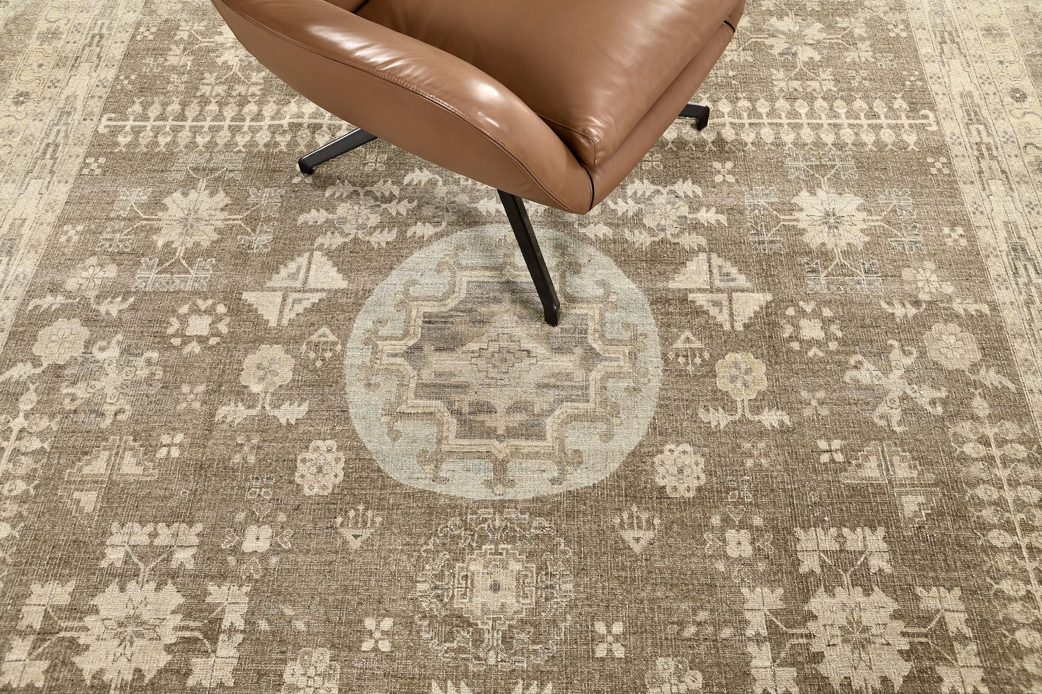 An impressive hand-spun wool Khotan design revival from our collection has come and flexed its versatility. Stylized motifs and historical symbols in a soft tone of sand manifest the entire pattern of the rug. This rug is flexible for any home