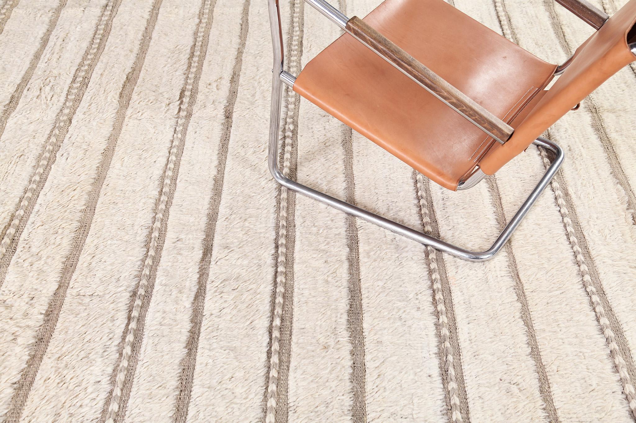 Abrolhos is a handwoven luxurious wool rug with timeless embossed detailing. In addition to its perfect cream and neutral flatweave, Albrohos has a beautiful shag that brings a lustrous texture and contemporary feel to one's space. The Haute