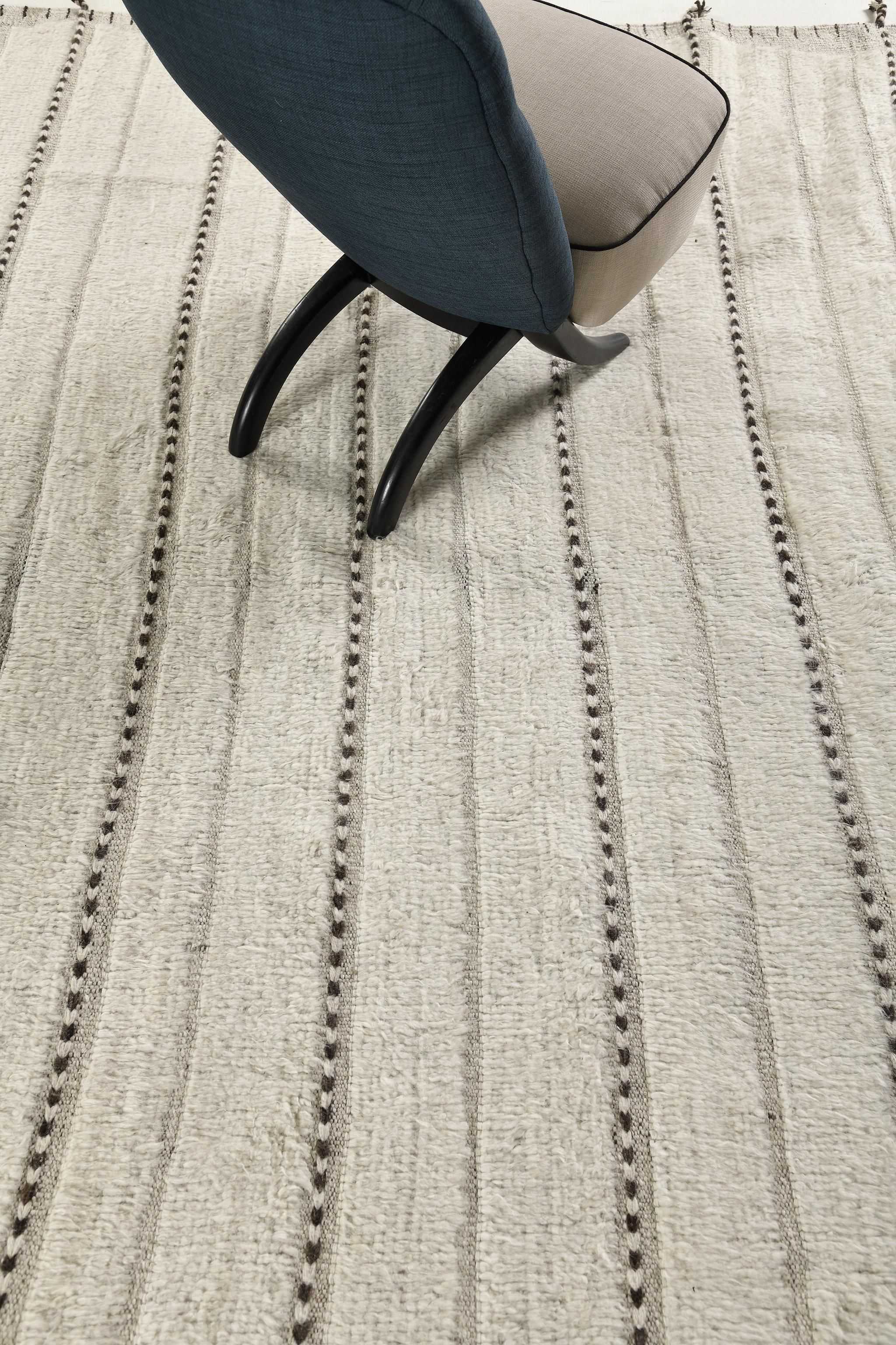 Abrolhos is a handwoven luxurious wool rug with timeless embossed detailing. In addition to its perfect ivory flatweave, Albrohos has a beautiful shag that brings a lustrous texture and contemporary feel to one's space. The Haute Bohemian collection