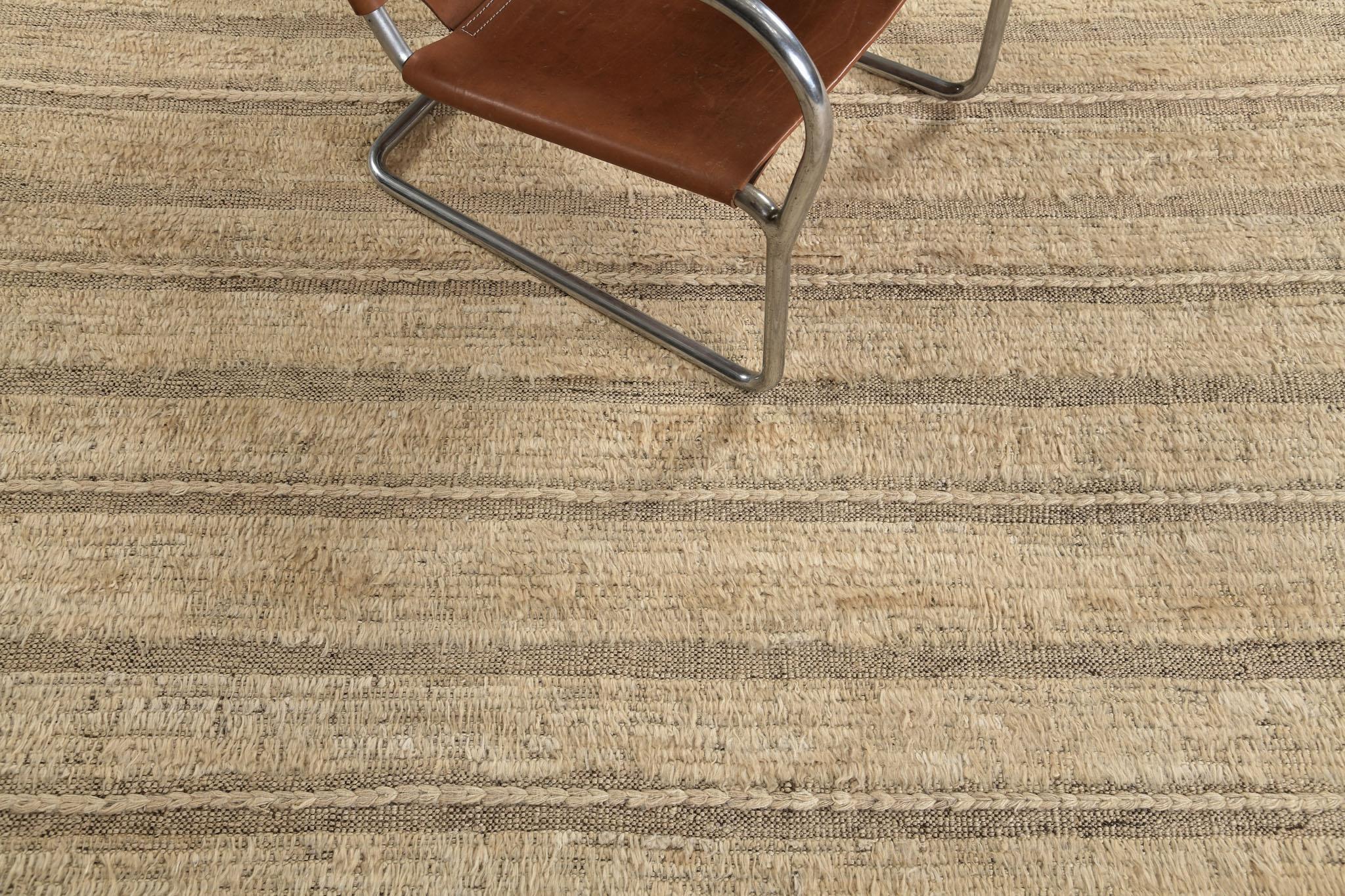 Abrolhos' is a handwoven luxurious wool rug with timeless embossed detailing. In addition to its perfect khaki flat weave, Albrohos has a beautiful shag that brings a lustrous texture and contemporary feel to one's space. The Haute Bohemian