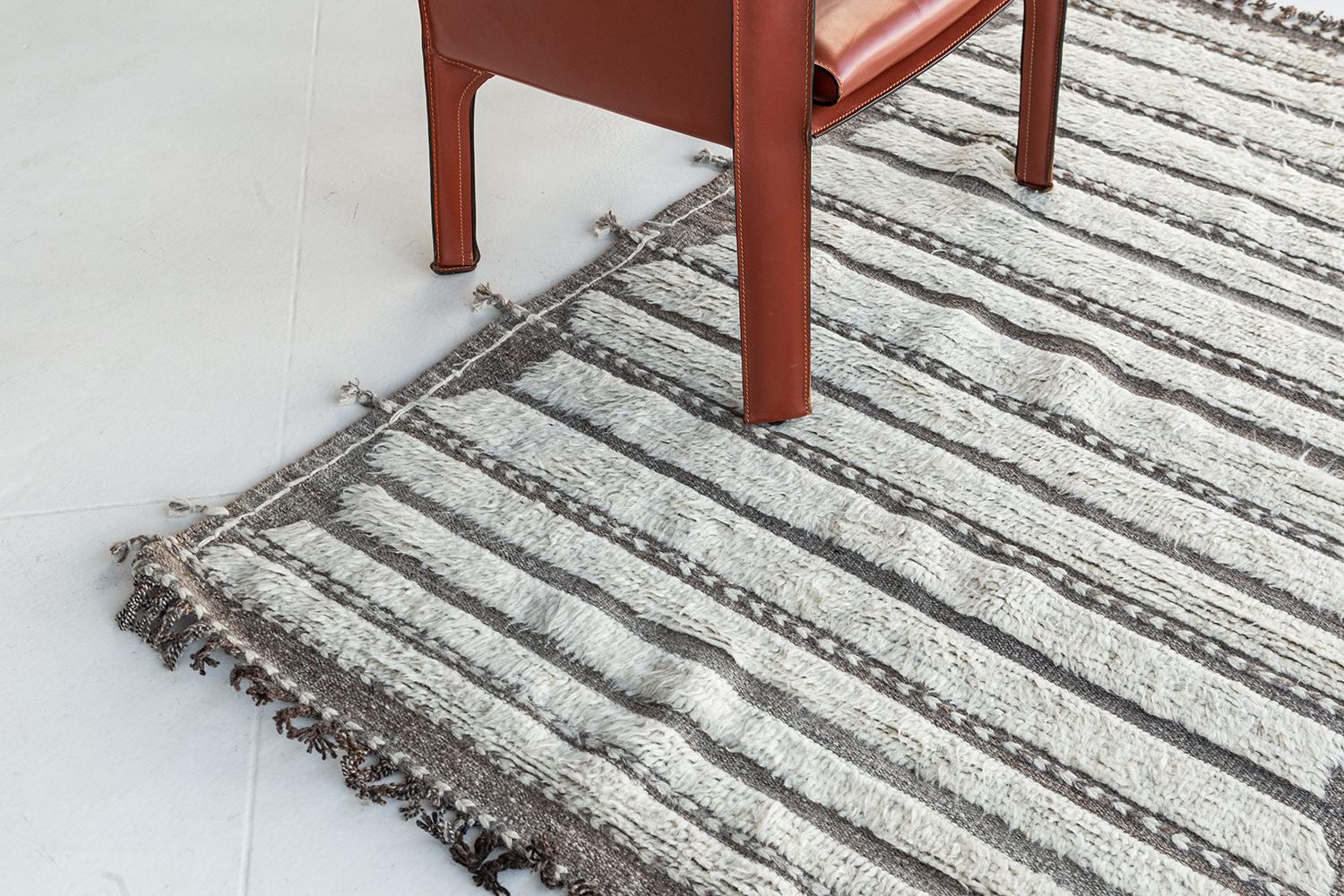 Abrolhos' is a handwoven luxurious wool rug with timeless embossed detailing. In addition to its perfect ivory flat weave, Albrohos has a beautiful shag that brings a lustrous texture and contemporary feel to one's space. The Haute Bohemian