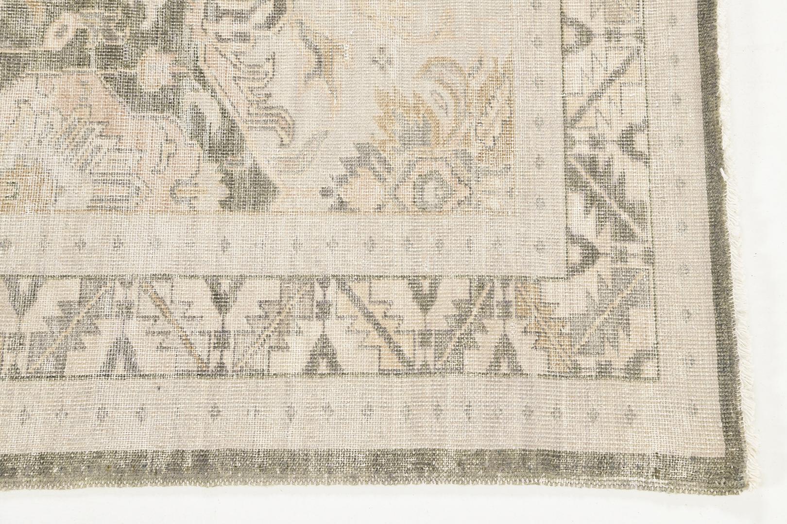Alsaeida is a distressed rug that features a series of symmetrical layouts of medallions in gold, with a color palette of ivories and gray. Its borders are magnificently woven and brilliantly designed to complement any interior. Excellent for the