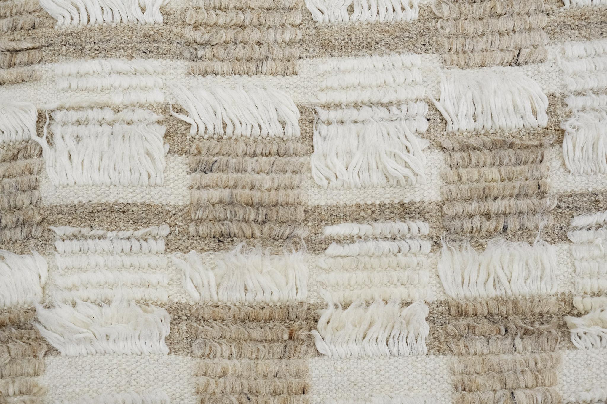The Amia rug interlaces horizontal stripe patterns of alternating pile heights, with openings of flatweave bands. This bright neutral colorway combines ivory and natural wheat tones.

An extension of Mehraban’s popular Amihan design, the Sahara