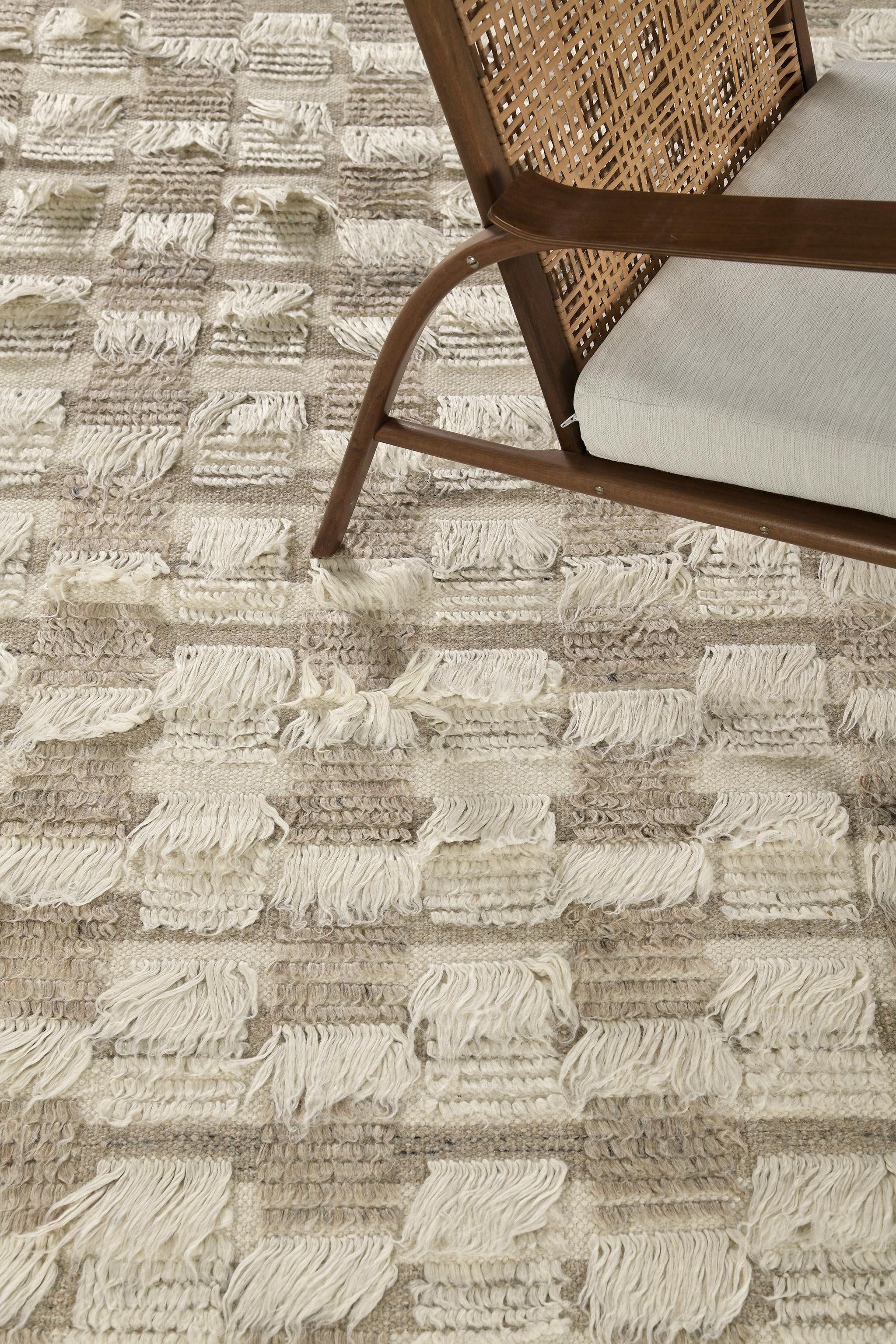 The Amia rug interlaces horizontal stripe patterns of alternating pile heights, with openings of flatweave bands. This bright neutral colorway combines ivory and wheat tones.

An extension of Mehraban’s popular Amihan design, the Sahara Collection