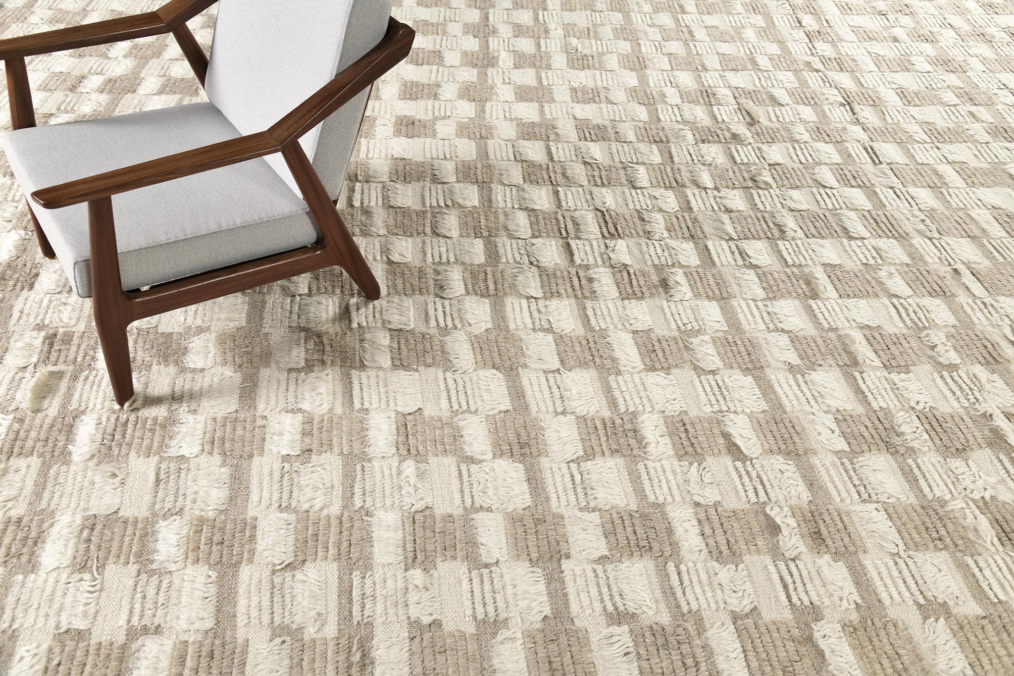 The Amia rug interlaces horizontal stripe patterns of alternating pile heights, with openings of flatweave bands. This bright neutral colorway combines ivory and wheat tones.

An extension of Mehraban’s popular Amihan design, the Sahara Collection