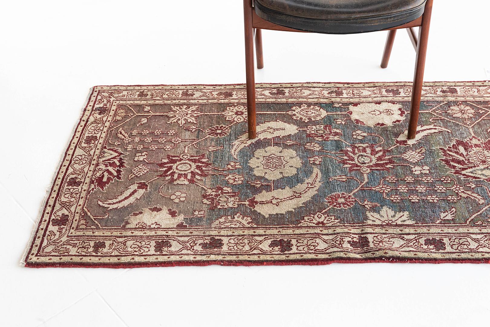 A gloriously dramatic Indo Agra rug features spiraling vines and florets. Known for their unique palette of color, nature schemes are flaunted. This masterwork of art gives a light and ethereal appearance which is gorgeous and impressive in any