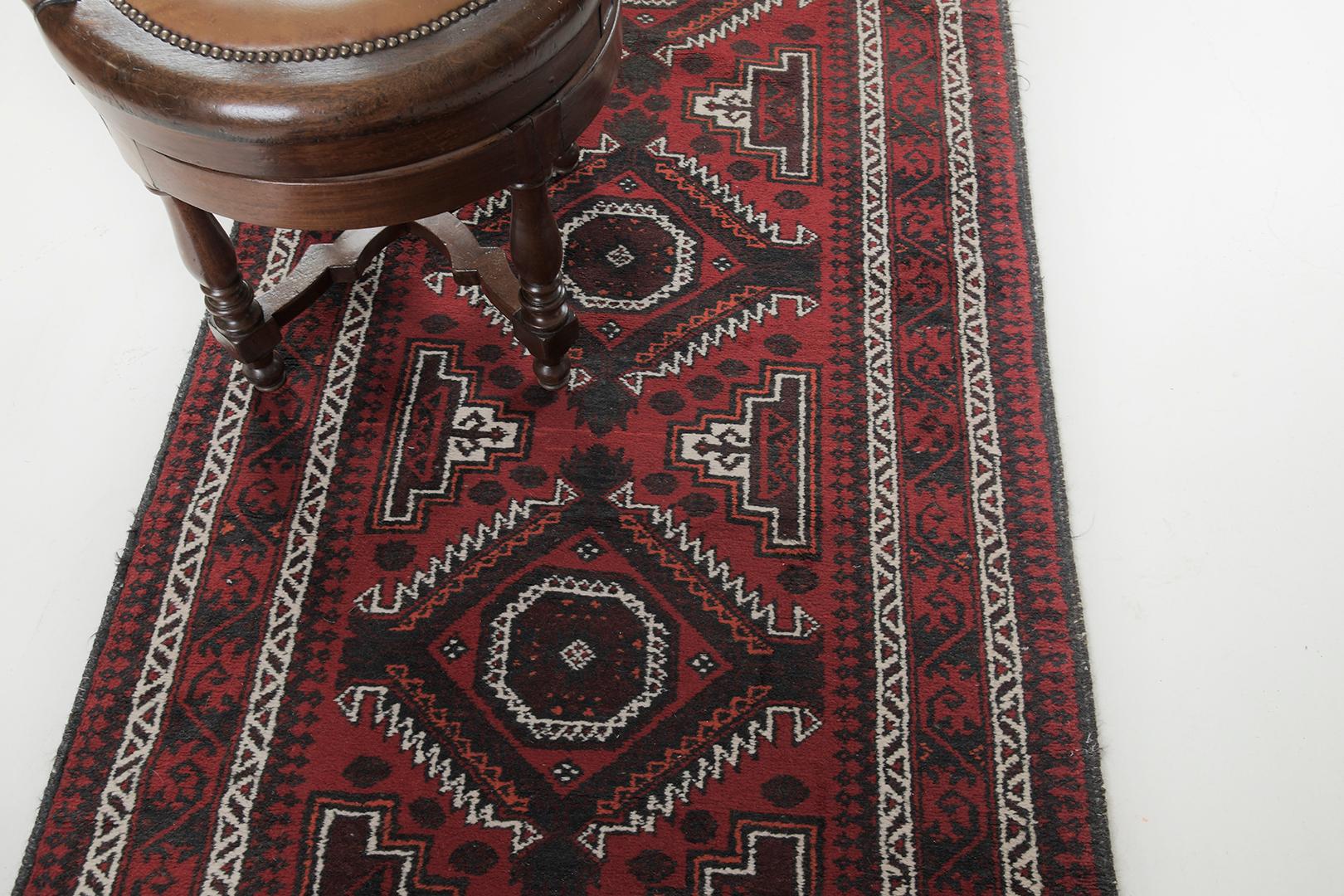 Our journey in the search for the best antiques has led us to this authentic and antique Persian Belouch runner rug. This centerpiece is made of wool in red dyes and the hatch pattern calls attention to your wall or floor application. A remarkable