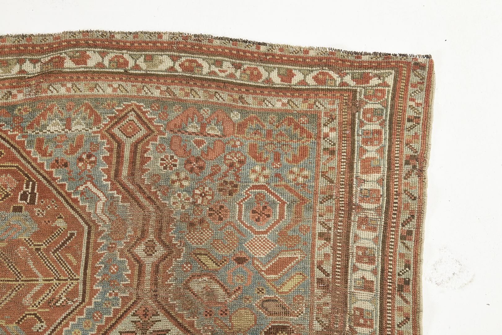 Who wouldn't fall in love with this Gashgai Persian Rug? Surrounded by bands that run along the perimeter of the rug. Variegated motifs and earth-tone palettes are ensembled to divulge a tale. This masterpiece is right for your traditional