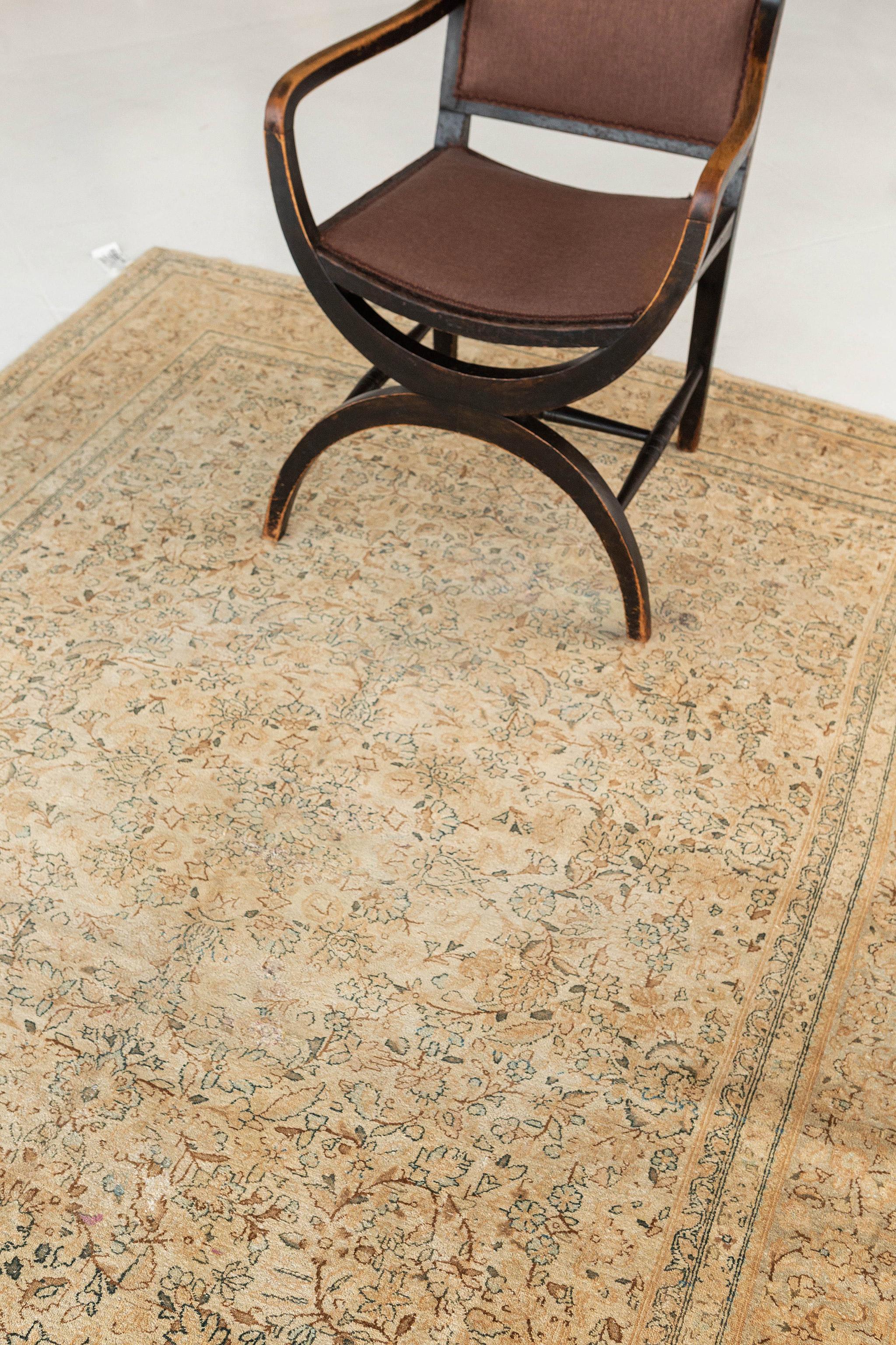 Classically composed and boasting a truly magnificent all-over garden design, this antique Persian Kerman rug reflects the finer points of timeless Central Asian rug trends. A variety of botanical elements, blossoms and vines are elegantly spread
