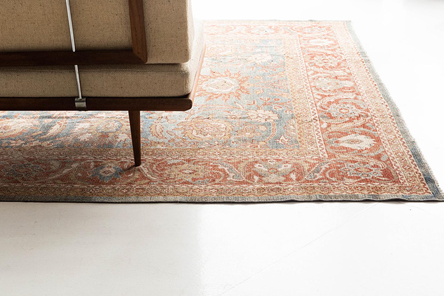 With its powerful details and intricacy, this Farahan rug created a timely design for modern and traditional settings. Warm tones are featured to the scrolling patterns and well-complement with the blooming motifs in a saturated blue field. A home