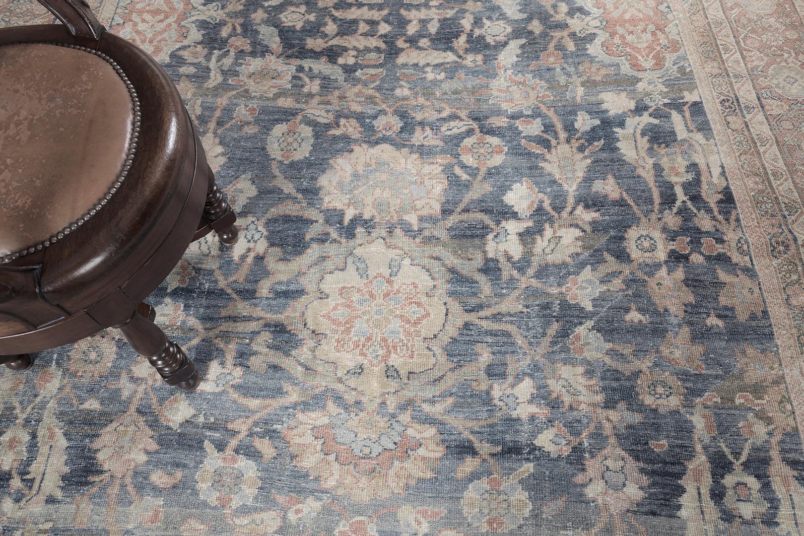 Feel the luxury vibes from our timeless collection that features the all-over florid patterns in midnight blue field surrounded by a warm color palette of scrolling patterns. This picturesque Persian Mahal rug provides a warm and friendly