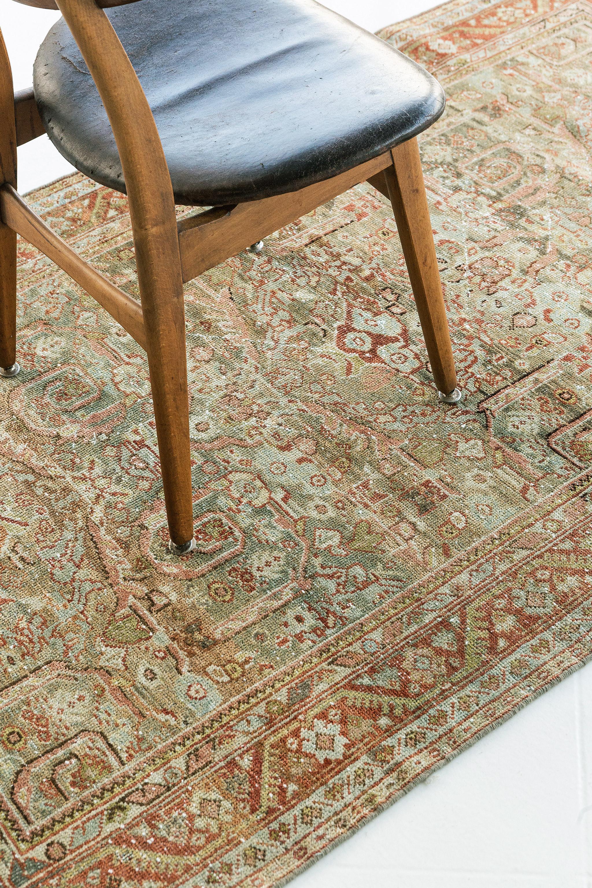 With captivating elements of curved lines and a subdued color scheme, this antique Persian Malayer rug embodies an all-over florid patterns that tells a story. The antique Malayer rug is adorned with an all-over pattern of swirls, curved sickle