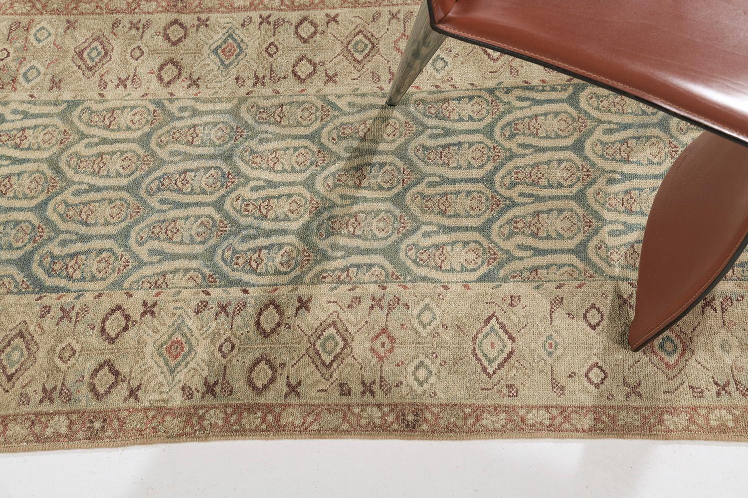 A remarkable hand-spun wool Persian Malayer Runner has immensely flexed its Bote-styled pattern along the perimeter of emblems and symbols in the teal ground. It is surrounded by different kinds of symbolic imprints in brown and gold elements. The