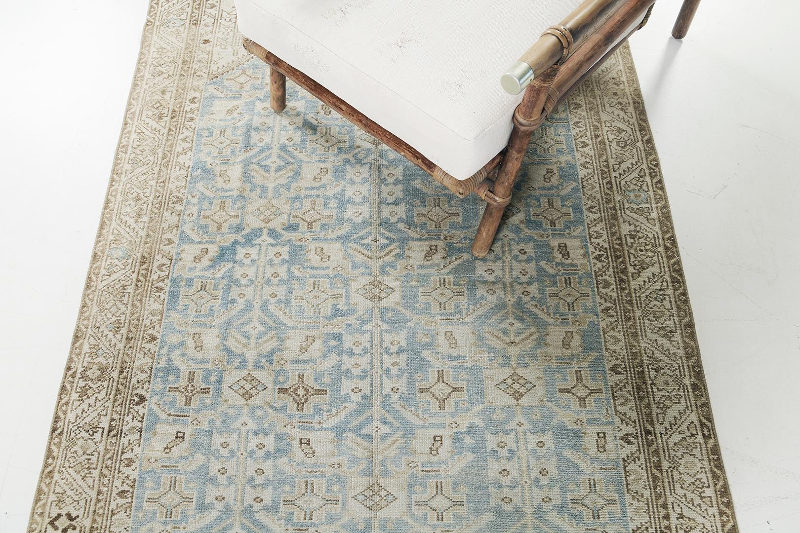 A magnificent Antique Persian Malayer Runner that boasts its alluring design. Featuring its intricate composition of geometric and botanical motifs, this exquisite rug features the cool tones of cerulean blue and ivory. The attention to detail and