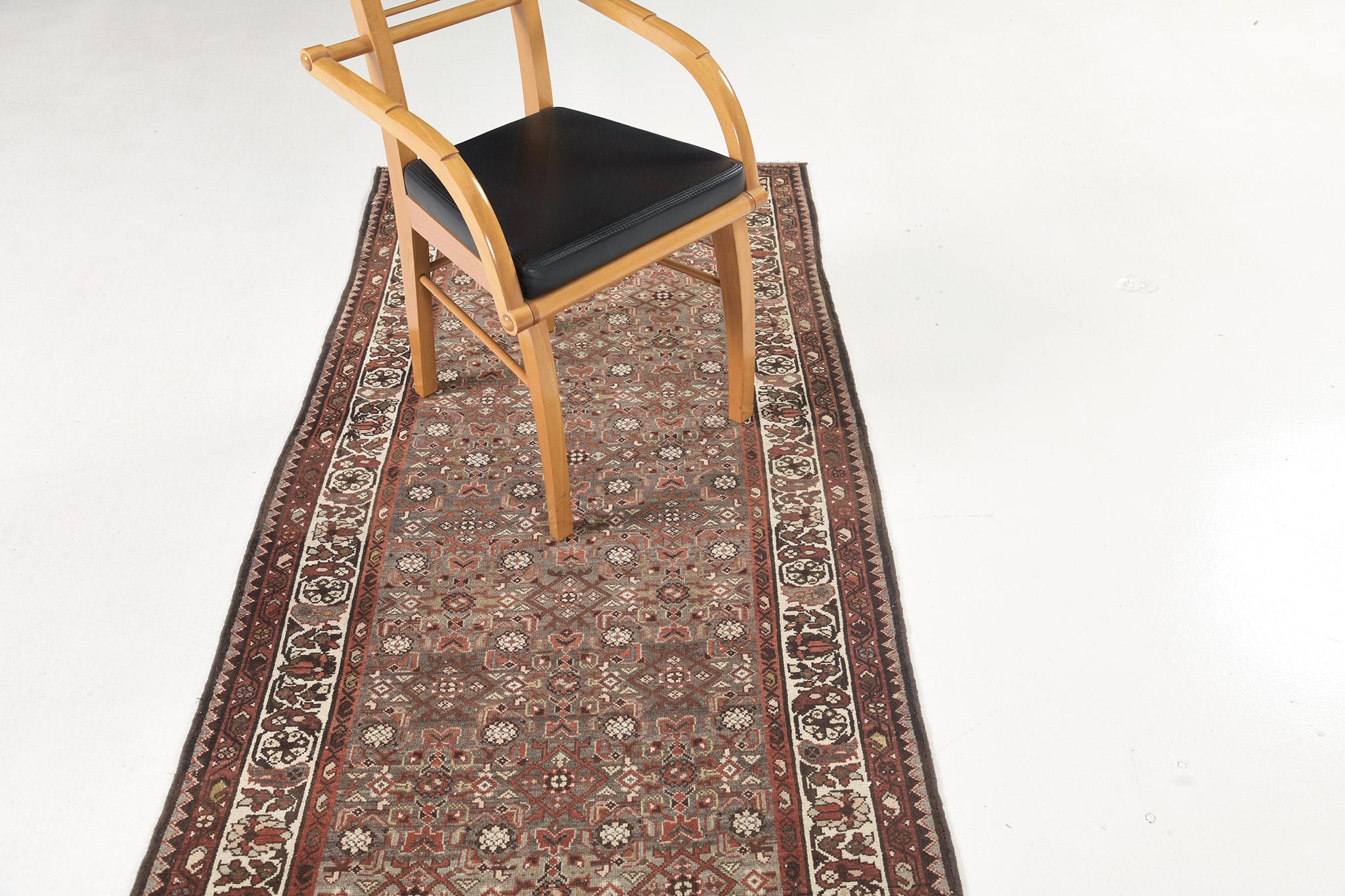 This gorgeous and timeless Persian Malayer runner carries an intricate symmetric patterns all over the design. A neutral tone color palette of field and elements is perfectly toned with ivory accents on its border. A perfect addition to your