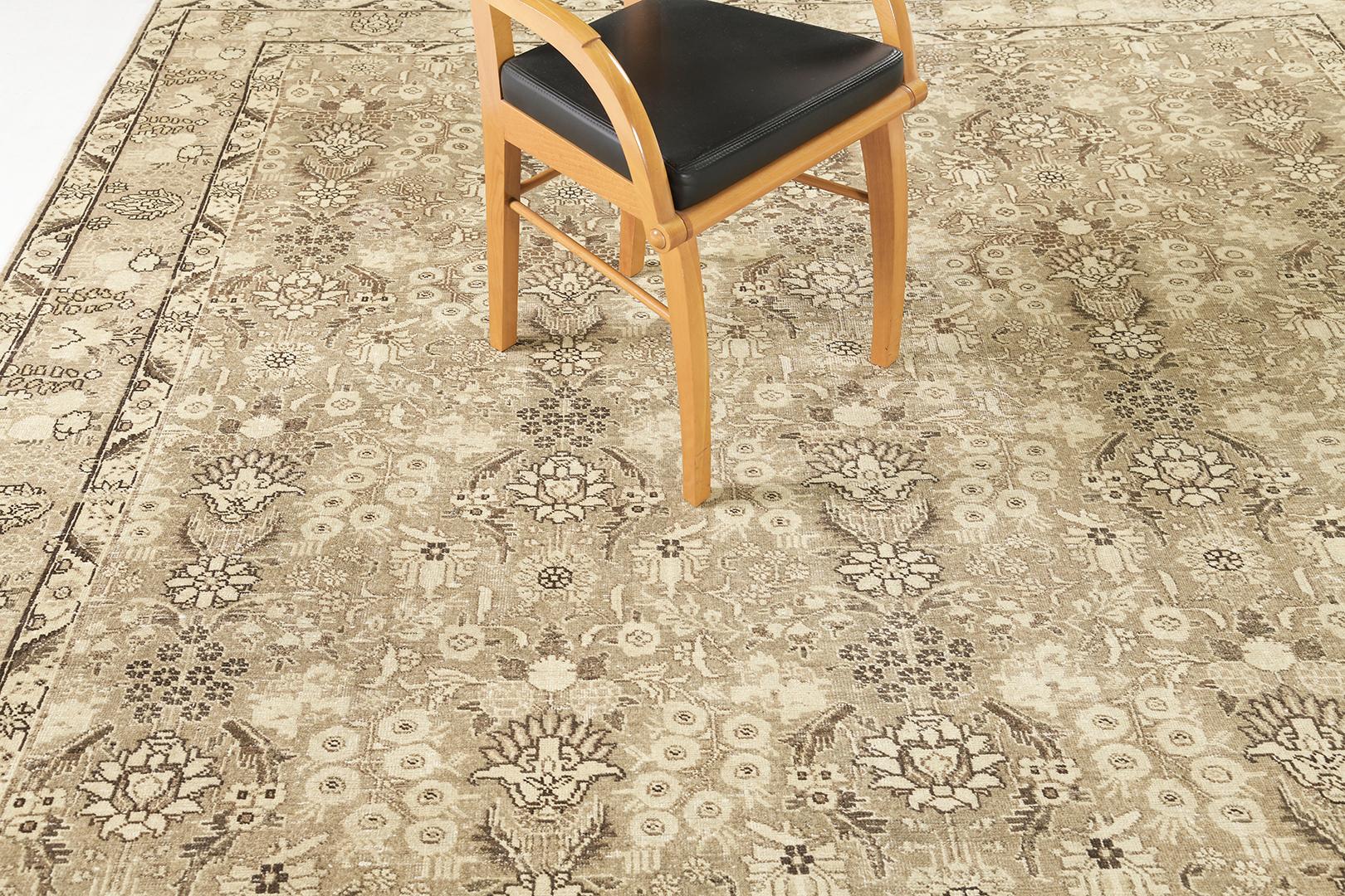 This timeless Tabriz Rug features a stunning pattern in a neutral field. A magical touch of peonies, daisies, carnations from all the shades of a neutral tone, and the scrolling vinery issuing split leaves are delicately woven around the rug. A