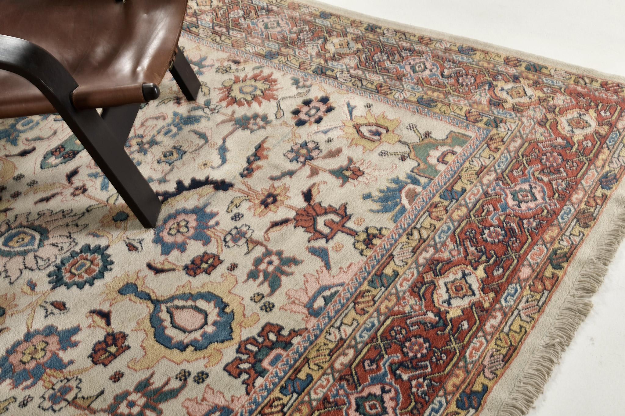This impressive Ziegler Persian rug features a combination of neutral and blue embellishments, a  soft cinnamon border, and rust motifs throughout. All-over field design with an intricate floral lattice pattern and equal density in stylized floral