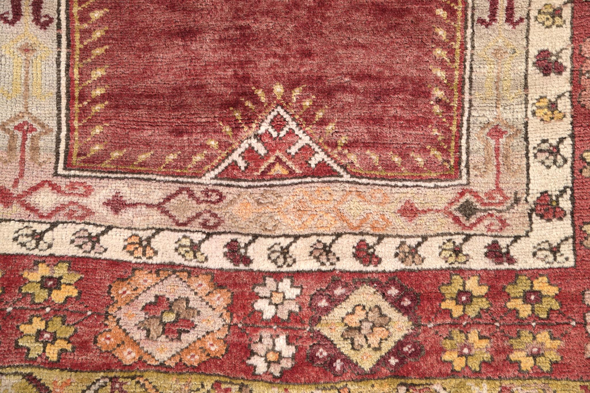 This Turkish Anatolian antique features a stronger construction method of Turkish knot and symbolic motifs. With its beautiful bright red, it will be a great match for every gold and white interior. Having this in your collection will be a hit with