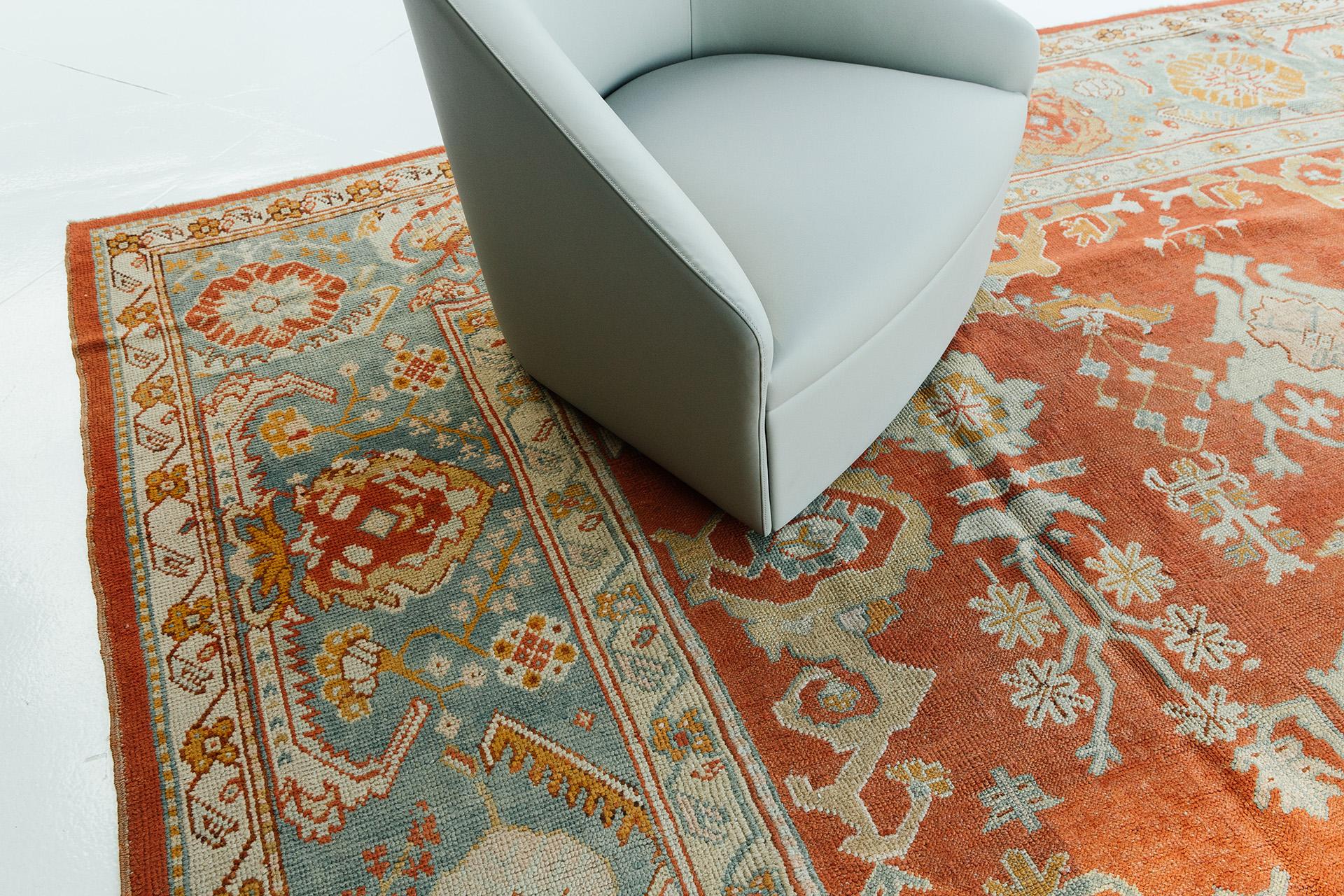 Our antique Turkish Oushak rug is beautifully constructed using the pile weave method out of high quality wool. The beautiful rust hue is featured centrally, and no picture can capture its magnificence. Use it in any application, whether it's the