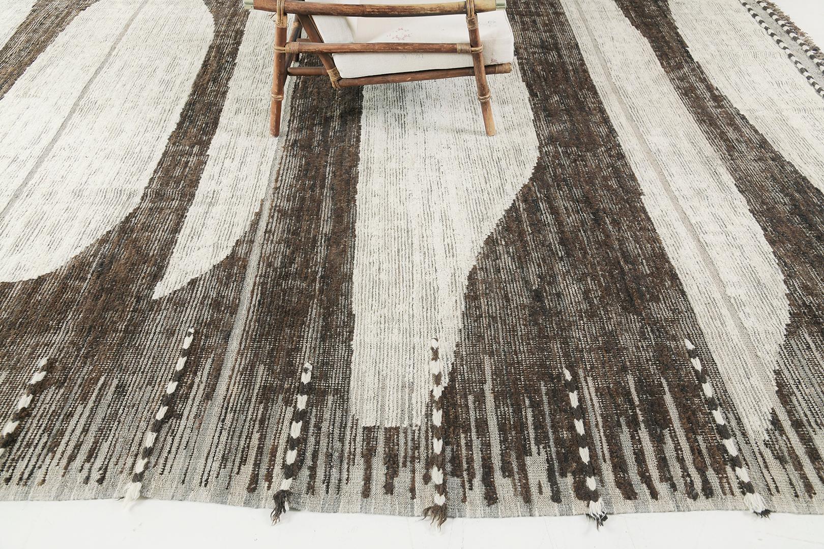Baddis présente des formes irrégulières disposées le long du champ brun qui renforcent le caractère apaisant de ce tapis captivant. Ce remarquable tapis fait preuve de sophistication et de simplicité véritable dans les tons remarquables d'ivoire et