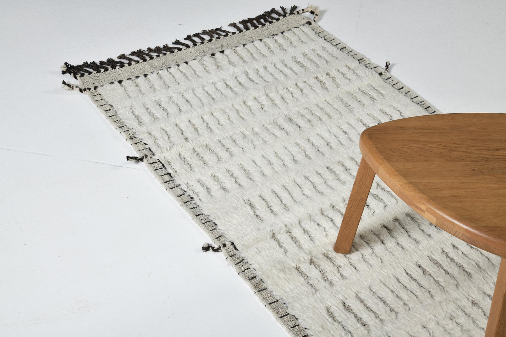 The signature Collection of California. Handwoven luxurious wool rug, made of timeless design elements and neutral earth tones with the perfect shade of ivory. Haute Bohemian Collection: designed in Los Angeles named for the winds knitting together