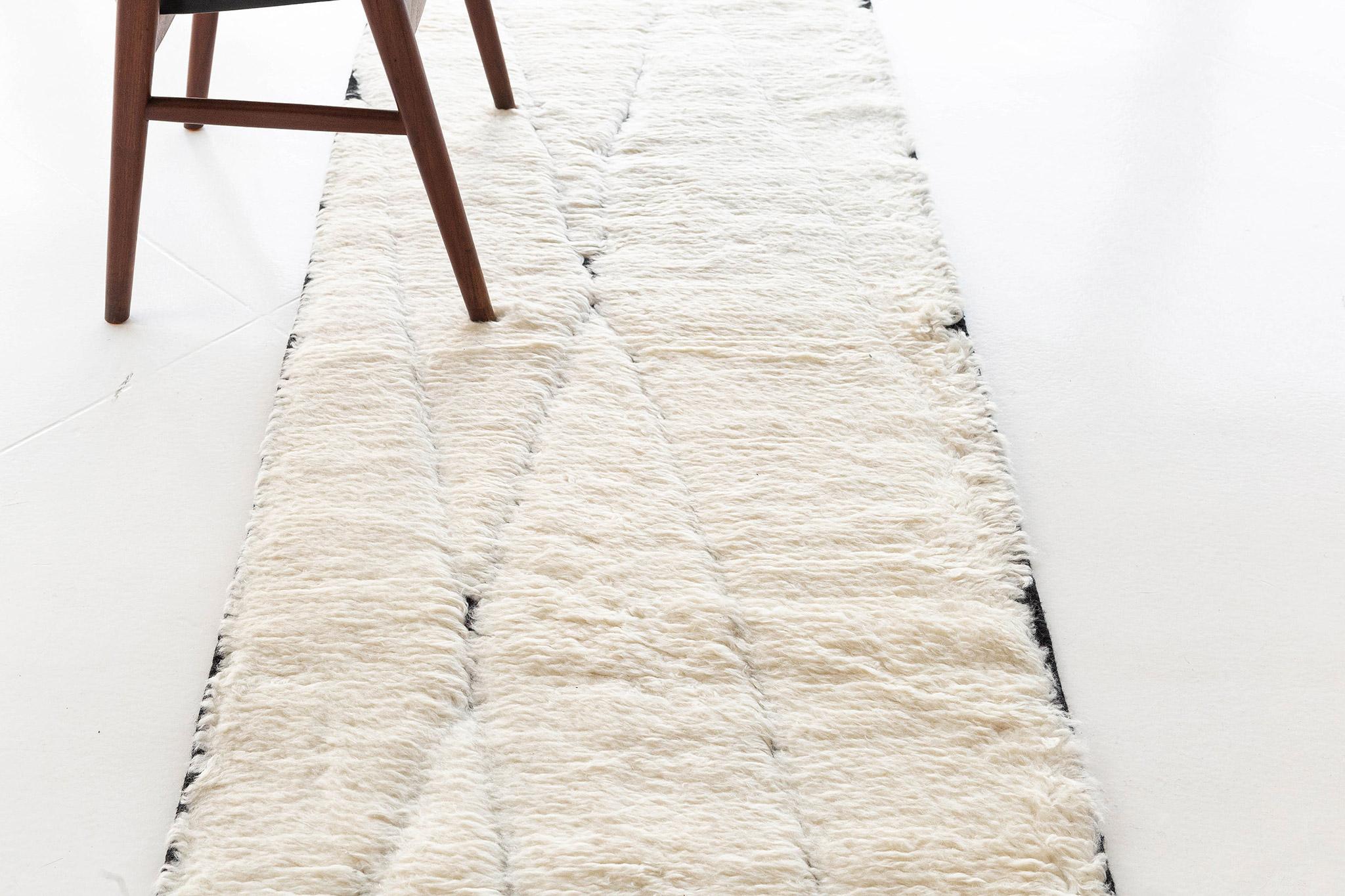 Featuring the most sought-after soft palette, this breath-taking Bise runner made from hand-spun wool will certainly captivate every stylish mind. The extended lozenges of Berber symbol in criss-cross featured in this masterful design will ooze