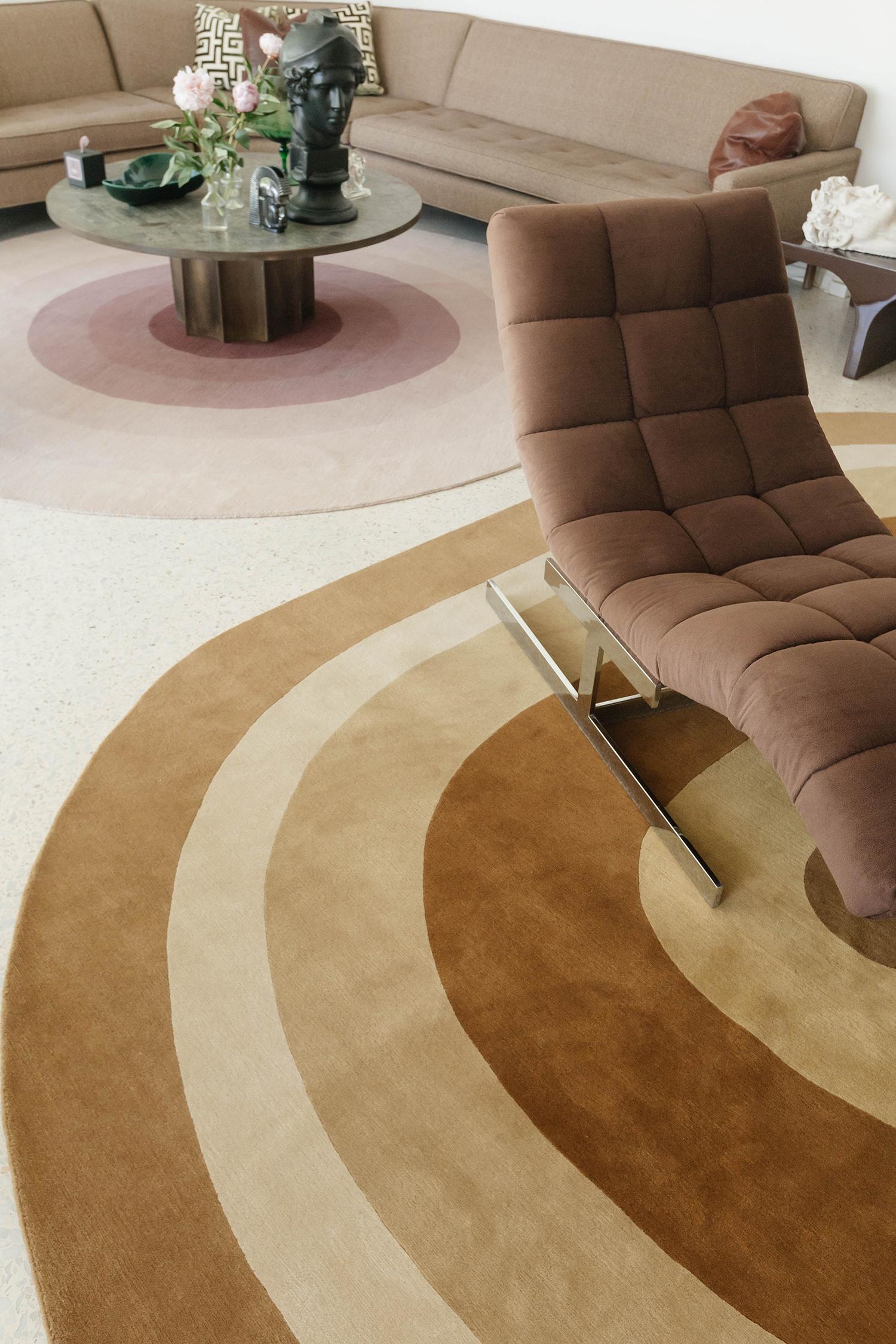 Clarion’ by Michael Berman features a direct approach to the rug’s viewer by visualizing a series of neutral colours and flow in its oval pattern. Rendered in the stunning shades of caramel, ivory and tortilla, this rug will definitely bring out a