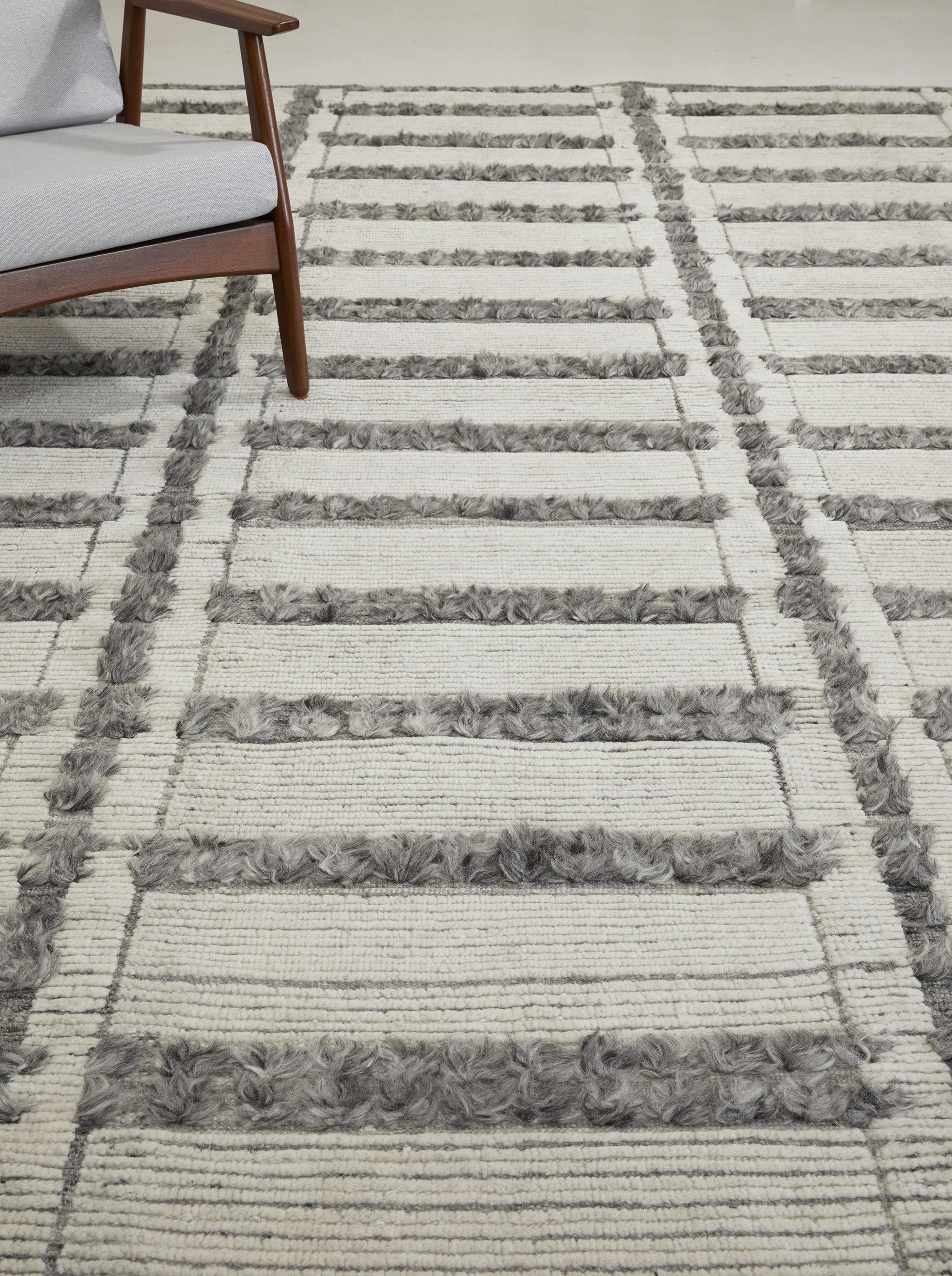 Ranks of long knots divide Colombard's trim pile and contrasting flatweave.

Here ivory pile contrasts with mottled grays.

The Estancia Collection by Mehraban is a group of casually sophisticated rugs in an array of upbeat colorways and design