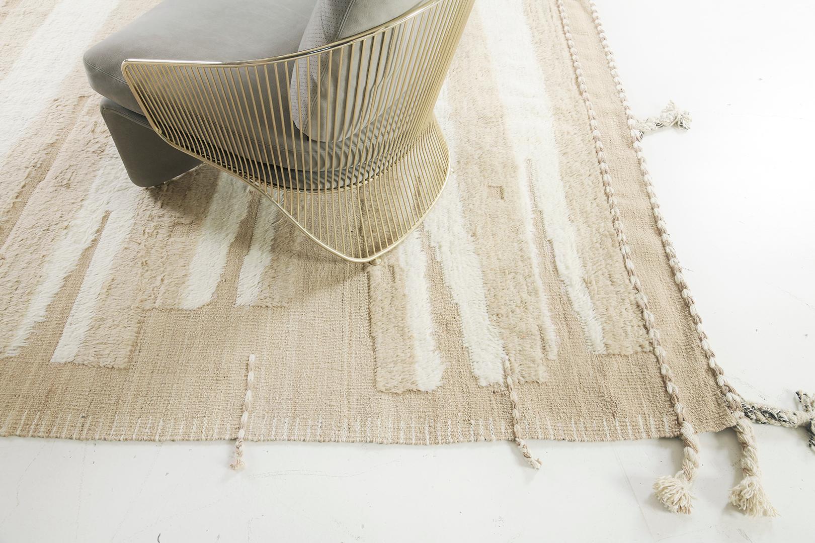 Darija' is a natural ivory handwoven flat-weave with embossed detailing streams in a sand and tan shag. Linework moving irregularly from top to bottom bring dimension and a sense of uniqueness for the modern design world. This collection, 'Kust'