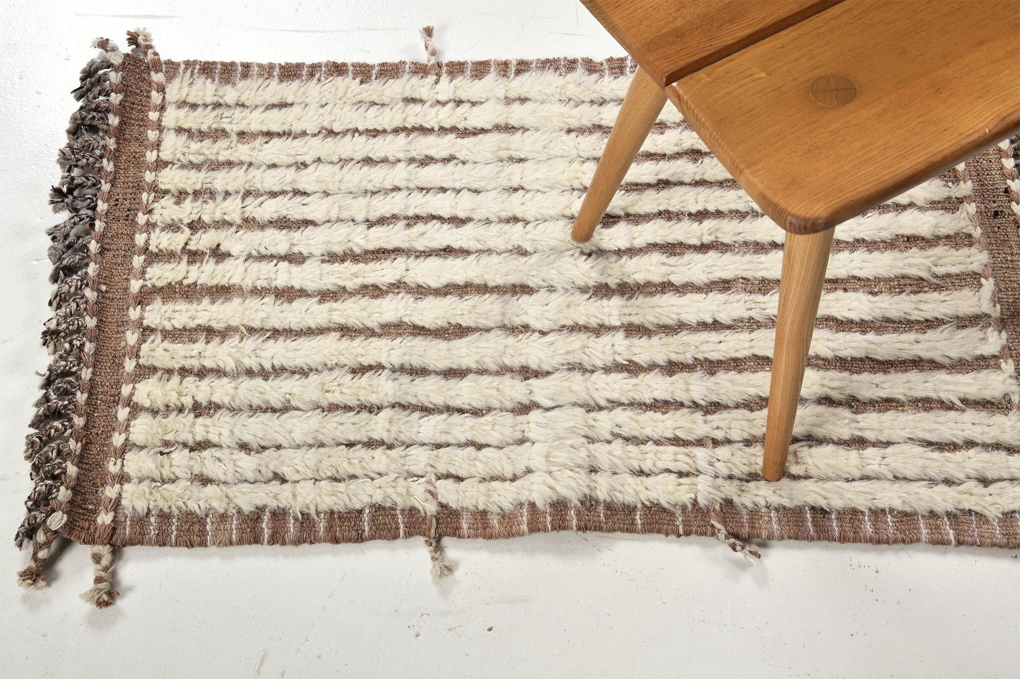 Fohn' is a handwoven luxurious wool rug with dainty embossed line detailing. In addition to its caramel toned flat-weave, Fohn has a perfect shag that brings a radiant and contemporary feel to one's space. The Haute Bohemian collection is designed