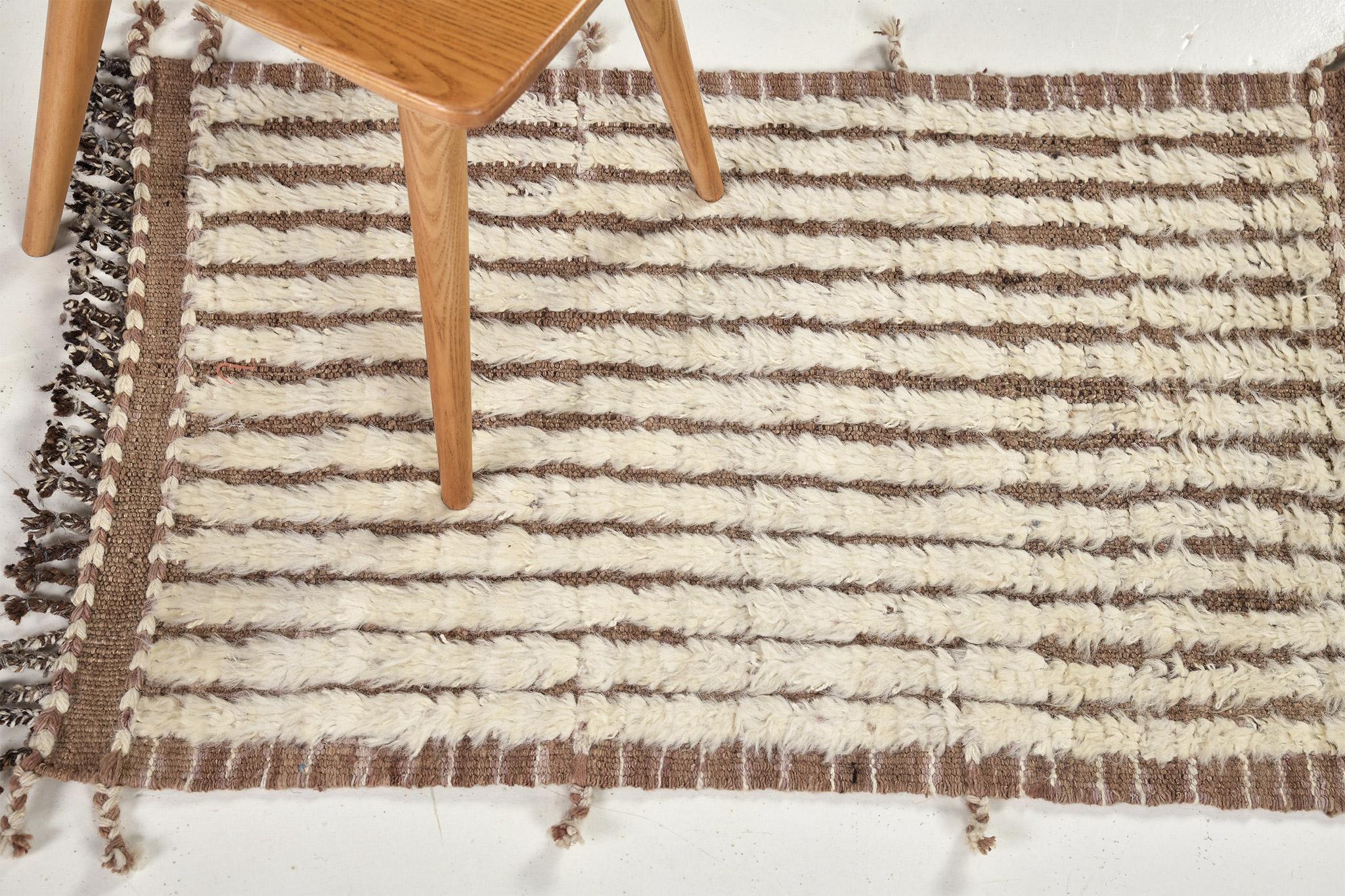 Fohn' is a handwoven luxurious wool rug with dainty embossed line detailing. In addition to its caramel toned flat-weave, Fohn has a perfect shag that brings a radiant and contemporary feel to one's space. The Haute Bohemian collection is designed