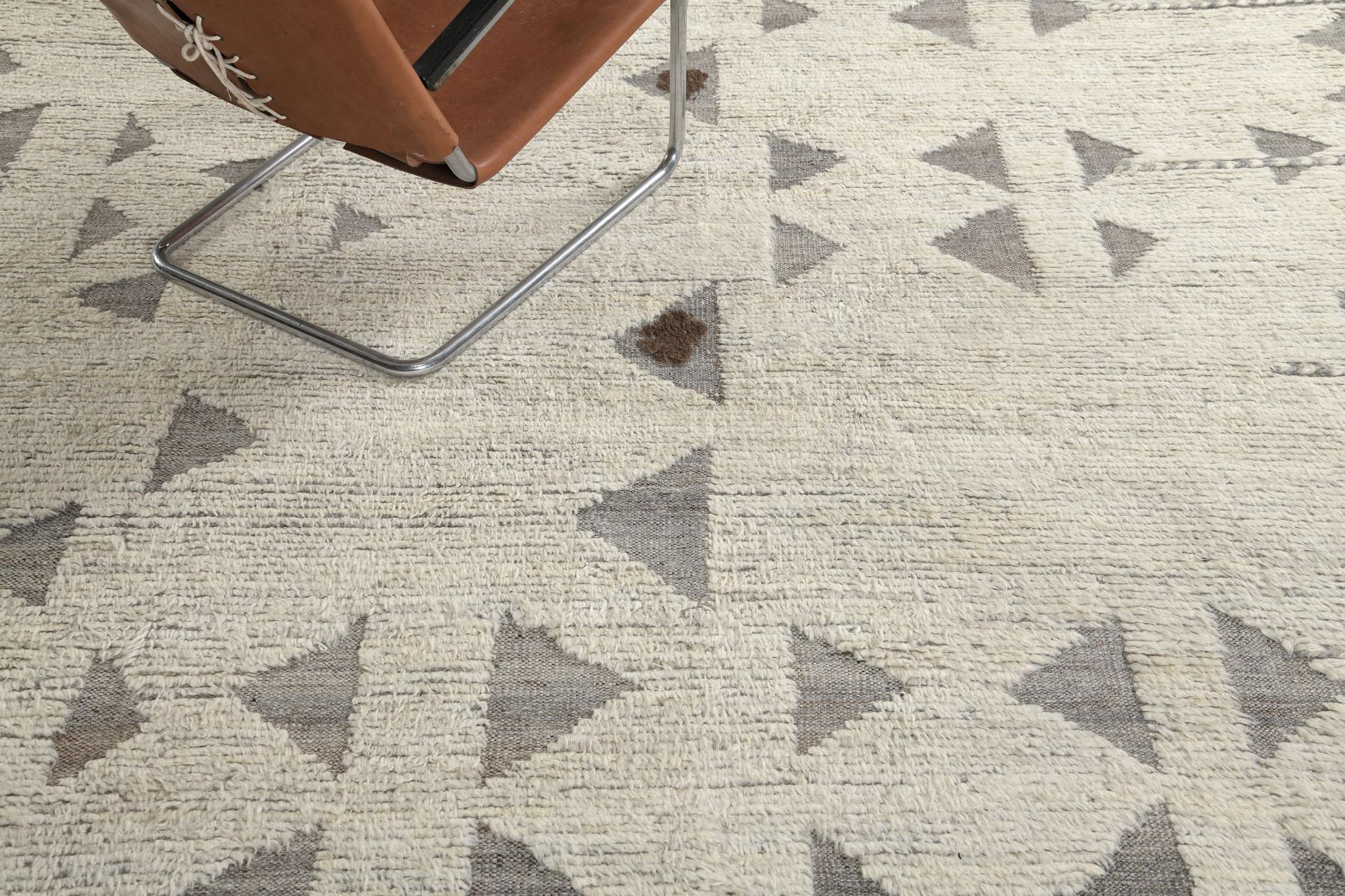 Gimbrala is a stunning handwoven neutral rug with embossed triangle detailing surrounding the perfect white pile. Beautiful tassels and bordered designs add a time and one-of-a-kind essence to the modern design world. Haute Bohemian Collection: