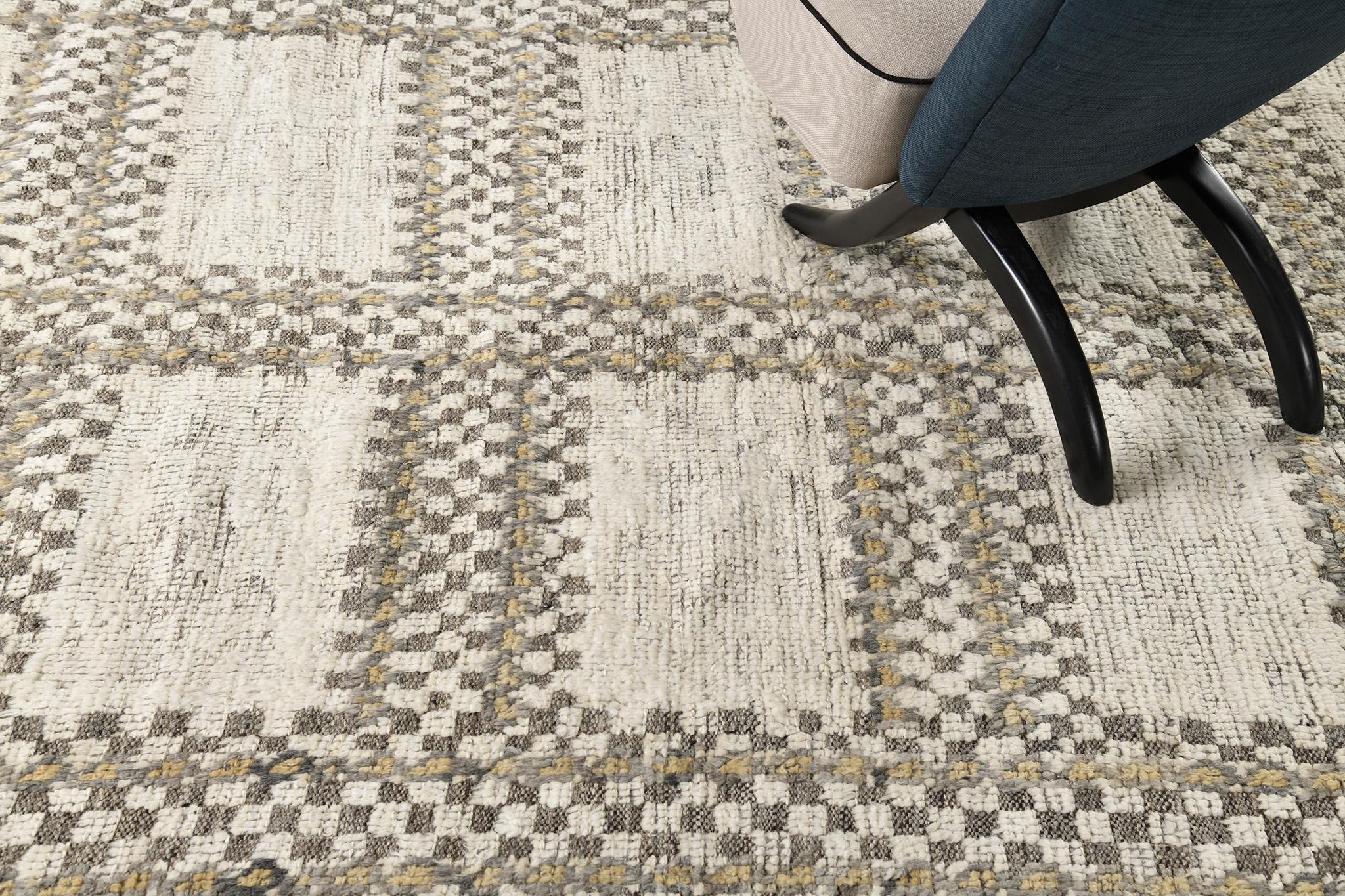 Gundiu’ in Nomad Collection features stunning gridlike patterns characterized by checkered motifs. This captivating rug boasts its earthy shades of ivory, taupe and camel that is perfect for minimalist interiors. Cozy and sophisticated, this rug