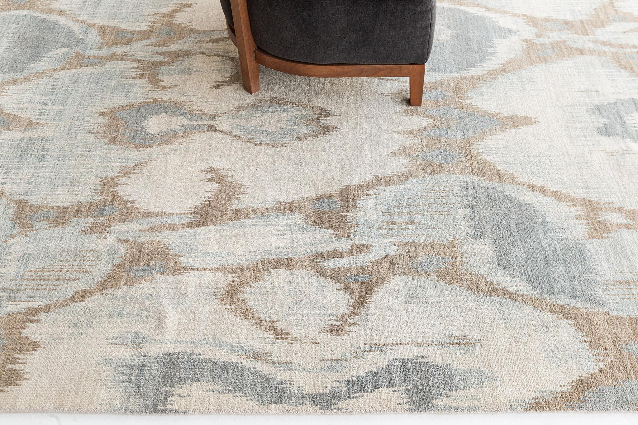 Berja' is an Ikat design rug that is both bold yet calming featuring its beautiful ocean blue, khaki and ivory hues. This wool pile weave will elevate any design space. Ikat designs are globally inspired for today's modern design world that will