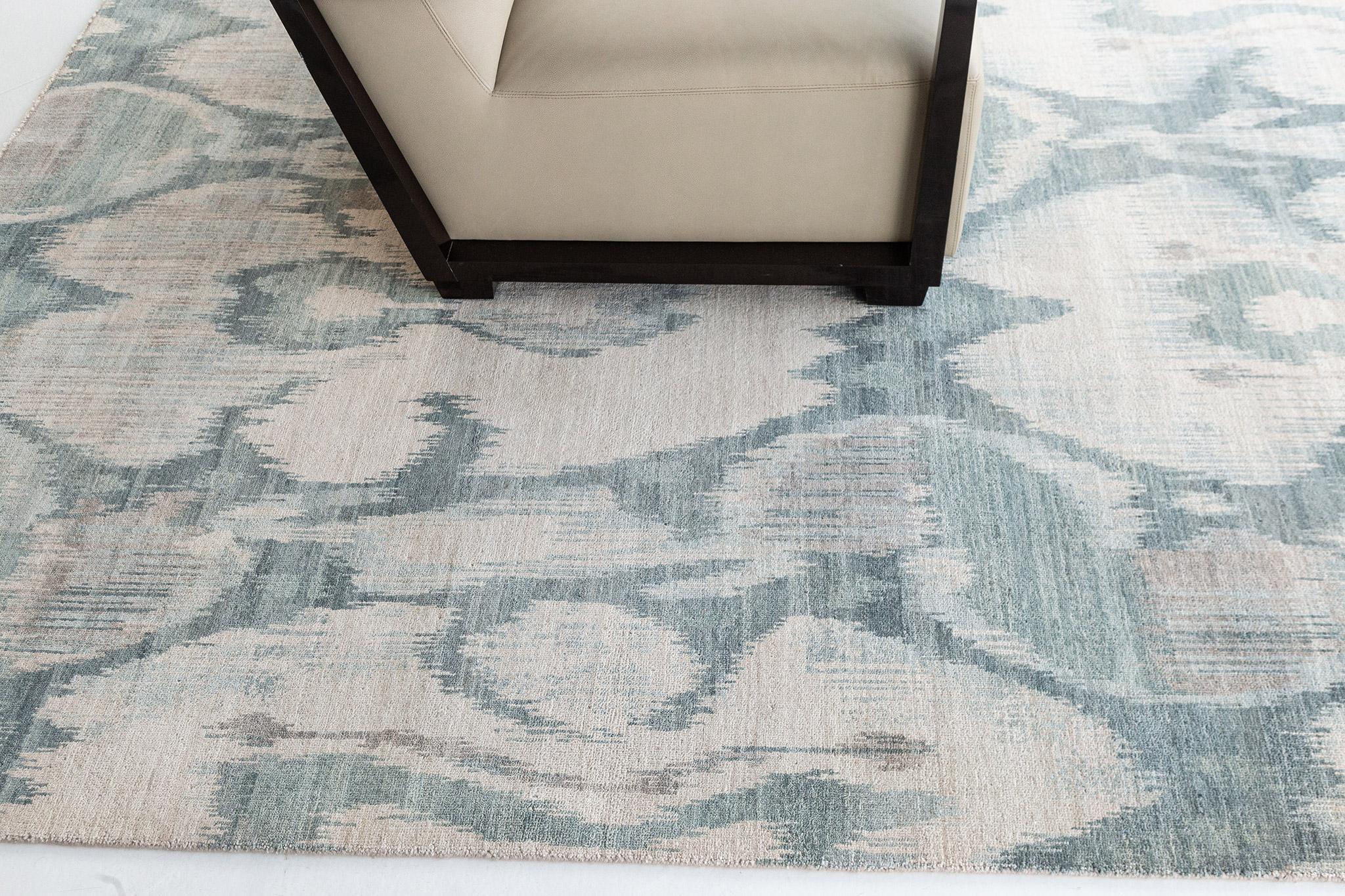 Berja' is an Ikat design rug that is both bold yet calming featuring its beautiful spring green and ivory hues. This wool pile weave will elevate any design space. Ikat designs are globally inspired for today's modern design world that will