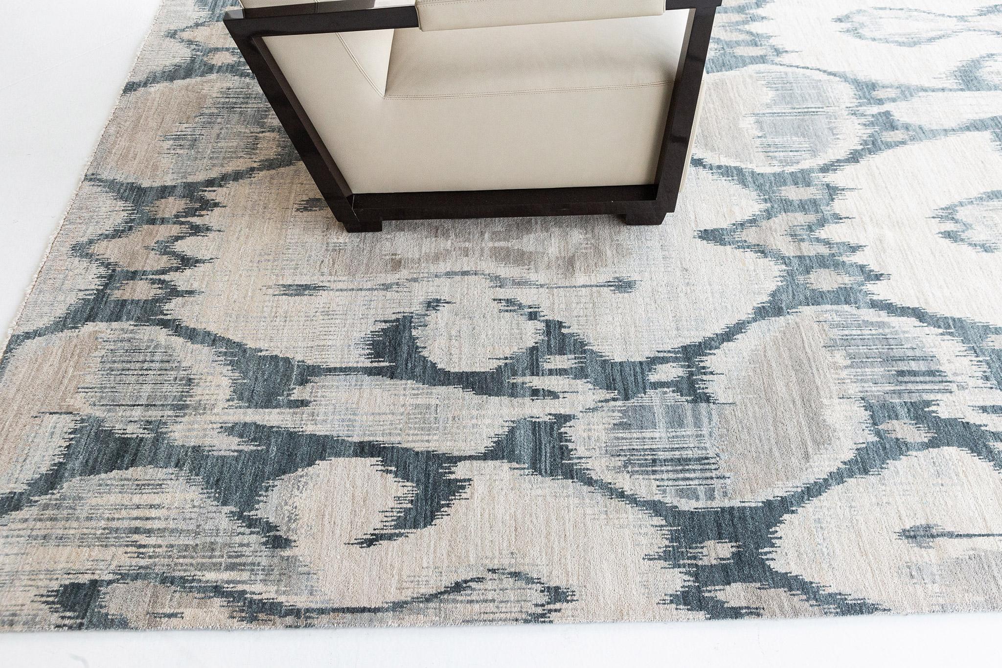Berja' is an Ikat design rug that is both bold yet calming featuring its beautiful ocean blue and ivory hues. This wool pile weave will elevate any design space. Ikat designs are globally inspired for today's modern design world that will definitely