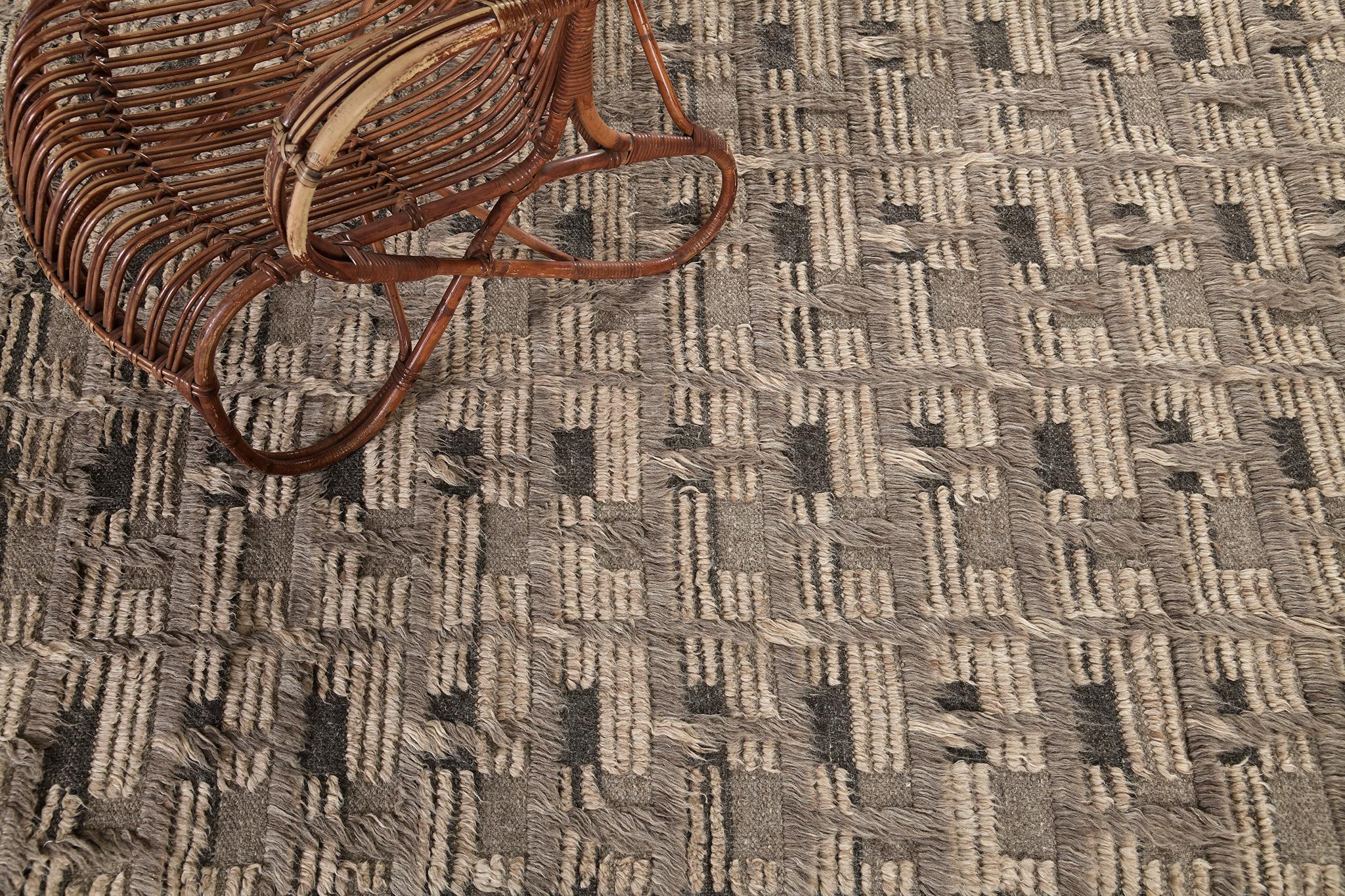 Imana is an intricate syncopated motif of long and short pile punctuated by squares of open flatweave in banded tones. Imana is available in two colorways, with custom options available. This piece features colors of mulled cacao on a striped