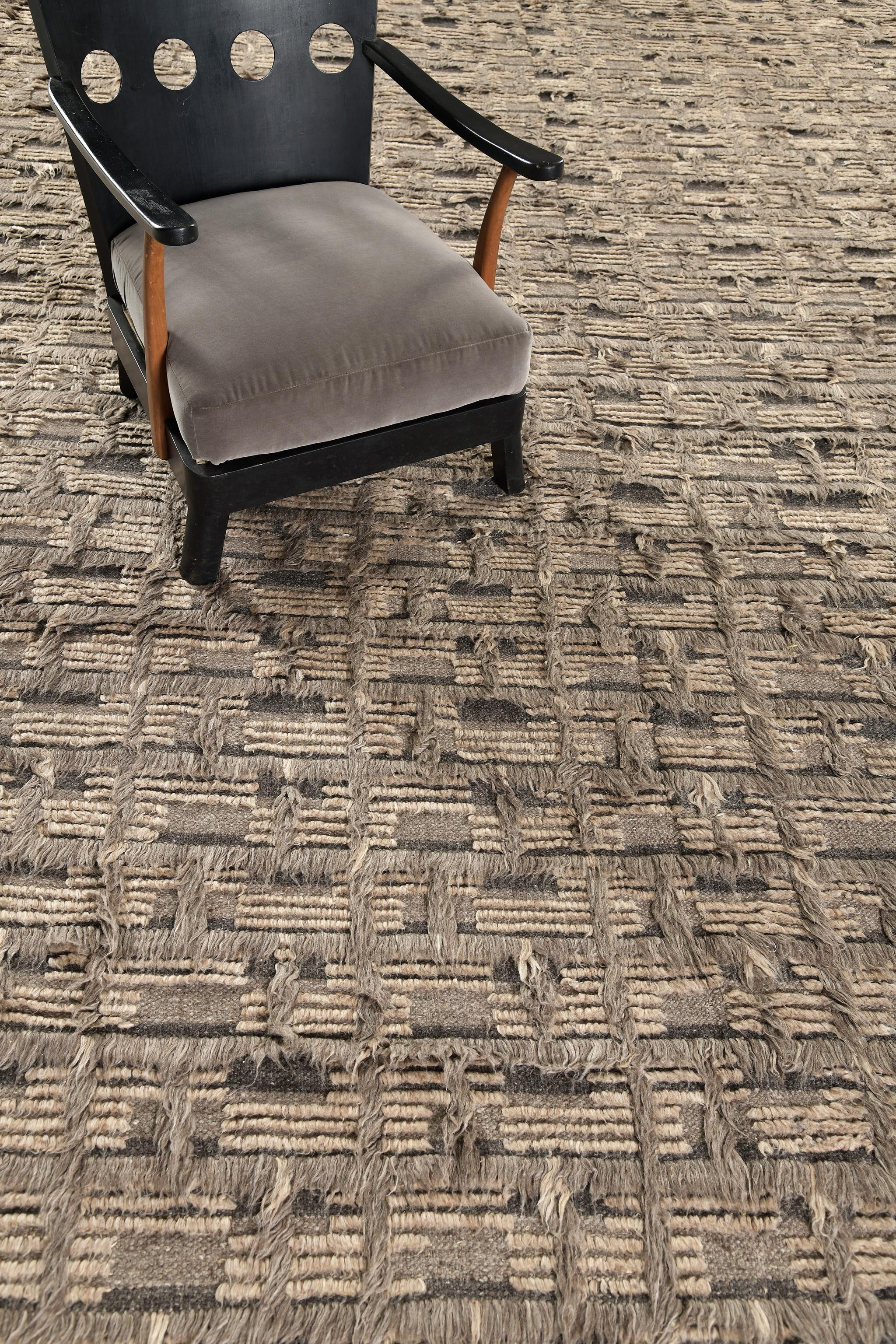 Imana is an intricate syncopated motif of long and short pile punctuated by squares of open flatweave in banded tones. Imana is available in two colorways, with custom options available.  This piece features colors of mulled cacao on a striped