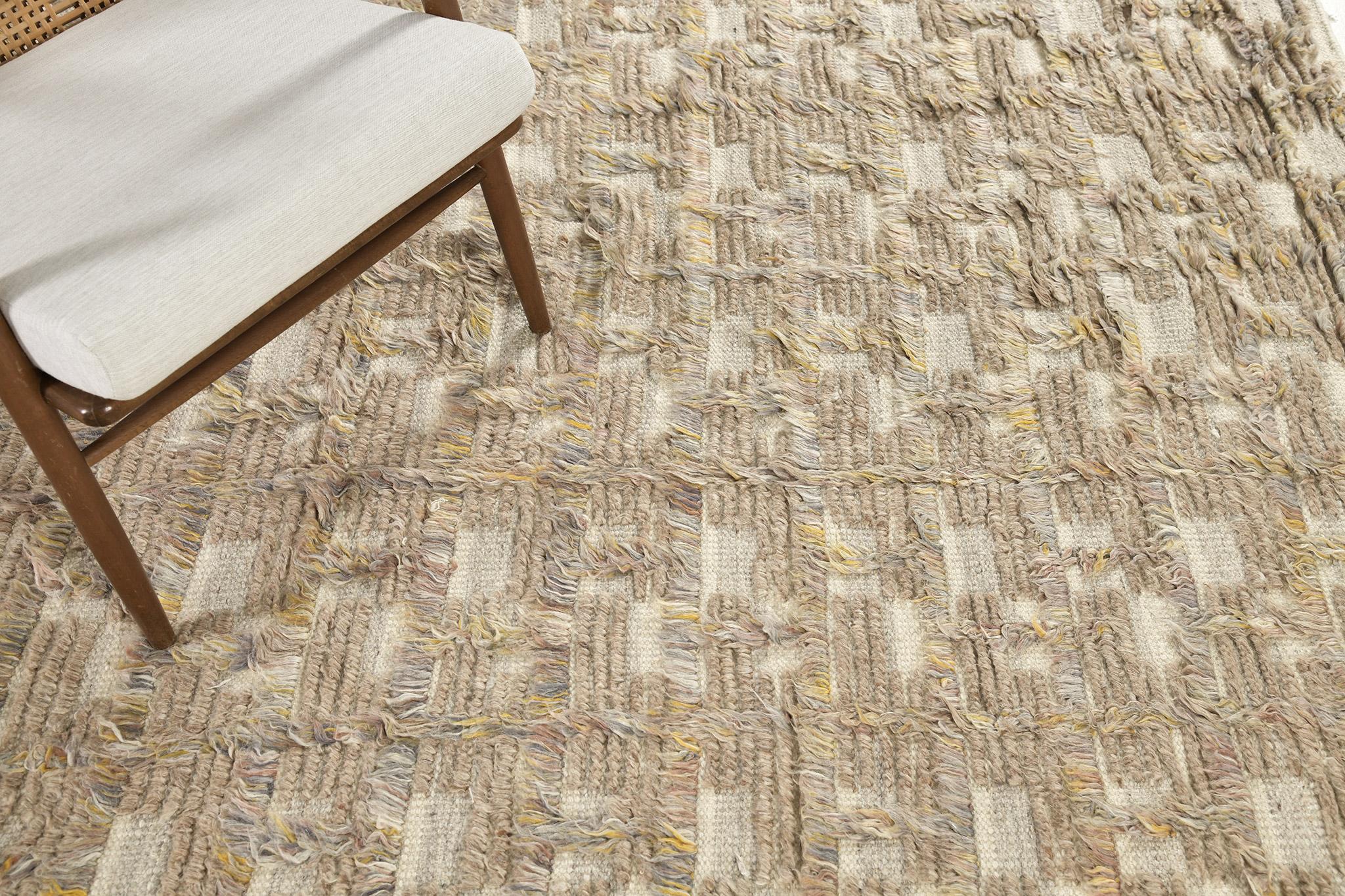 Imana is an intricate syncopated motif of long and short pile punctuated by squares of open flatweave in banded tones. Imana is available in two colorways, with custom options available. This piece features heathered clay-taupe colors, with dappled