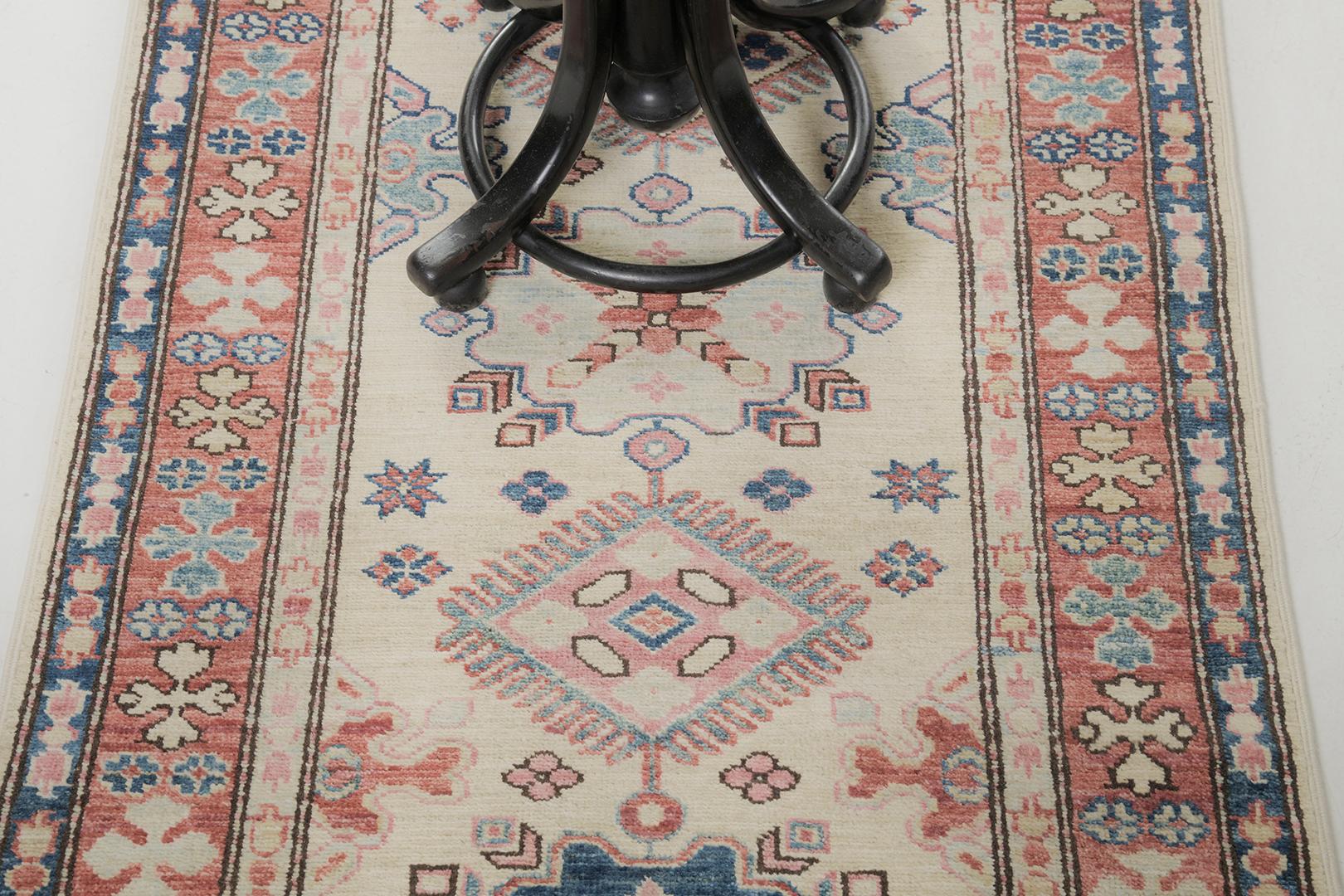 Behold and see the elegance of Kazak Design rug revival from our collection. Tones of blue, tan, and cream featured the symmetrical and outline details of hexagonal medallions, symbolic elements, and all. Furniture that has a minimalist idea, makes