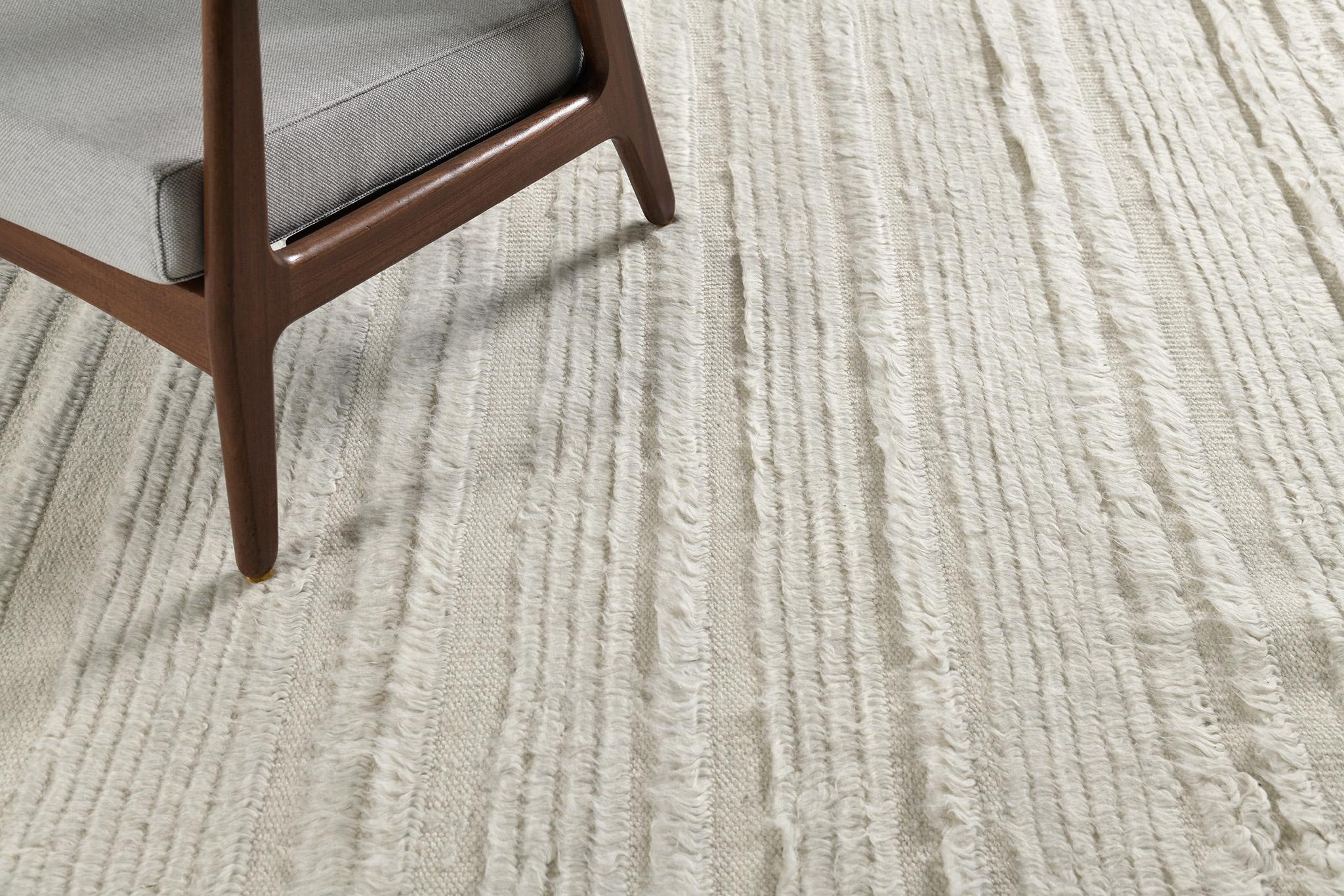 Kit Moresby II is luxurious wool that features embossed varying degrees of lines. Perfect decor for any home space because of its simplicity and modern-day interpretation. Mehraban's Atlas Collection is known for its intuitive motifs, saturated