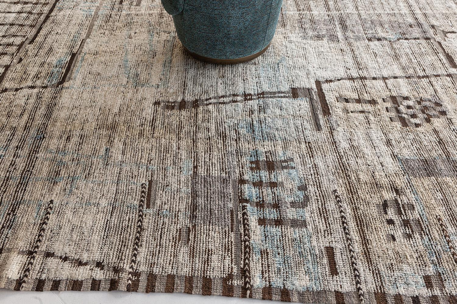 Meliska' is an exquisitely textured rug with irregular motifs inspired from the Atlas Mountains of Morocco. Earthy tones of ivory and chocolate brown surrounded by umber brown shag work cohesively to make for a great contemporary interpretation for