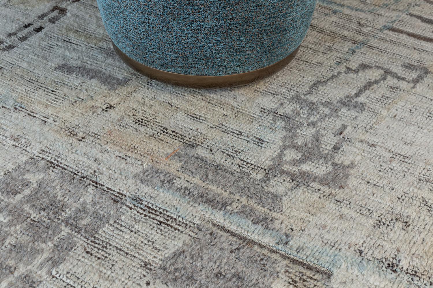 Meliska' is an exquisitely textured rug with irregular motifs inspired from the Atlas Mountains of Morocco. Earthy tones of ivory and chocolate brown surrounded by umber brown shag work cohesively to make for a great contemporary interpretation for