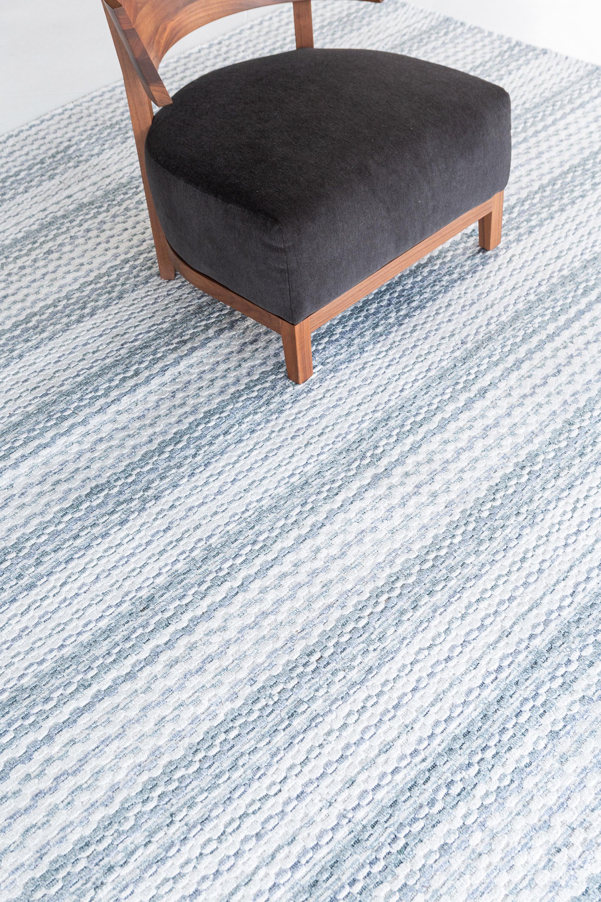 A fascinating modern hand loom rug in our Luca Collection. The delicate ribbed style rug in variegated shades of blue give it a sophisticated and beguiling feel. Repeating pile detailing also brings a tranquil and noteworthy uniqueness to this
